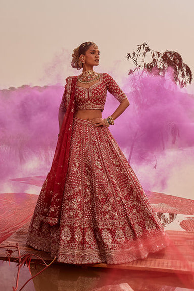 Woman in a traditional outfit with pink smoke effect in a scenic setting