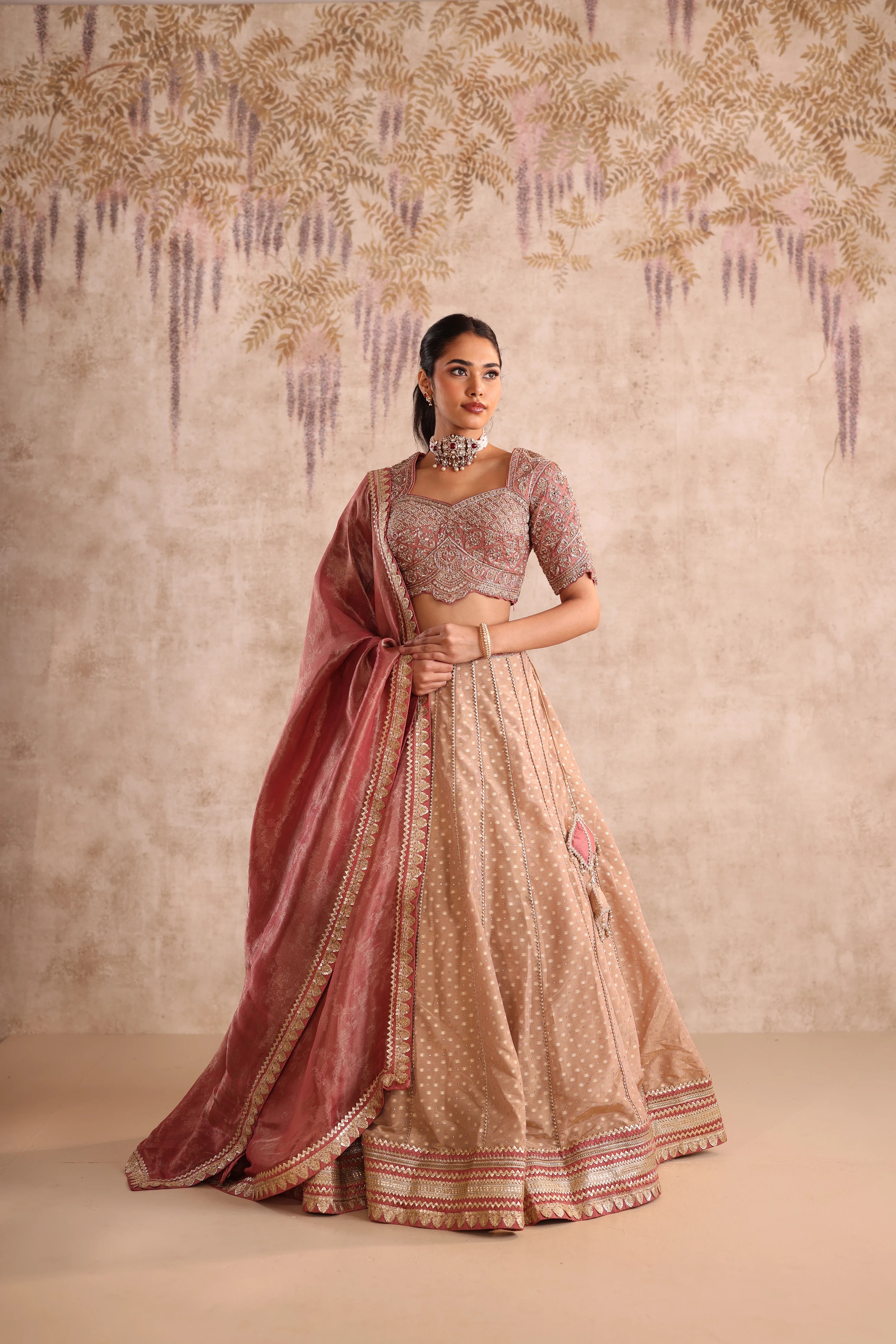 Woman in a traditional outfit with a decorative background