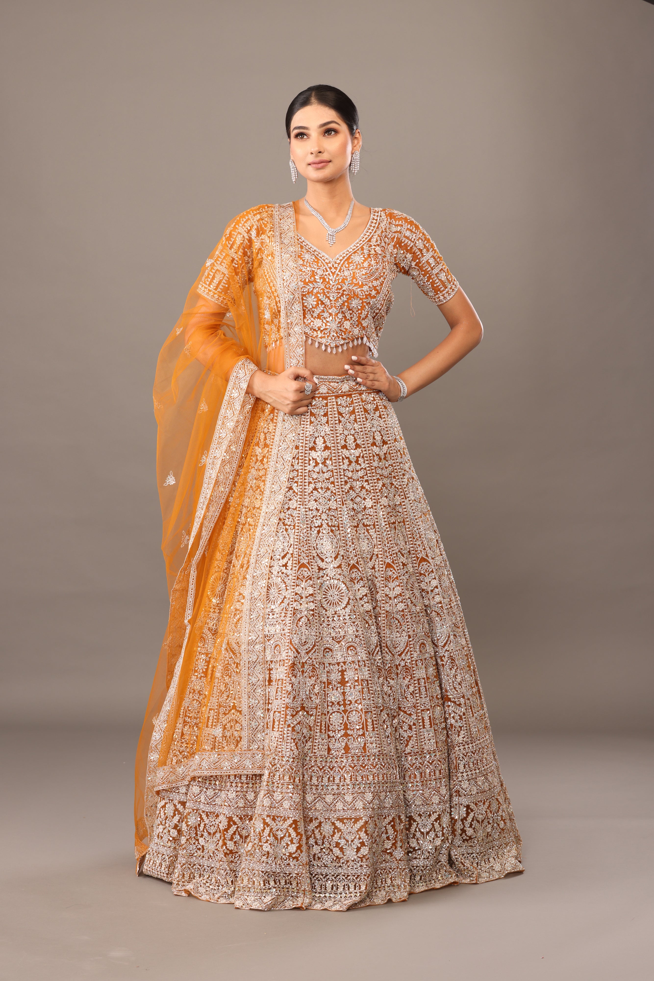 Yellow net lehenga with heavy white tread embroidery