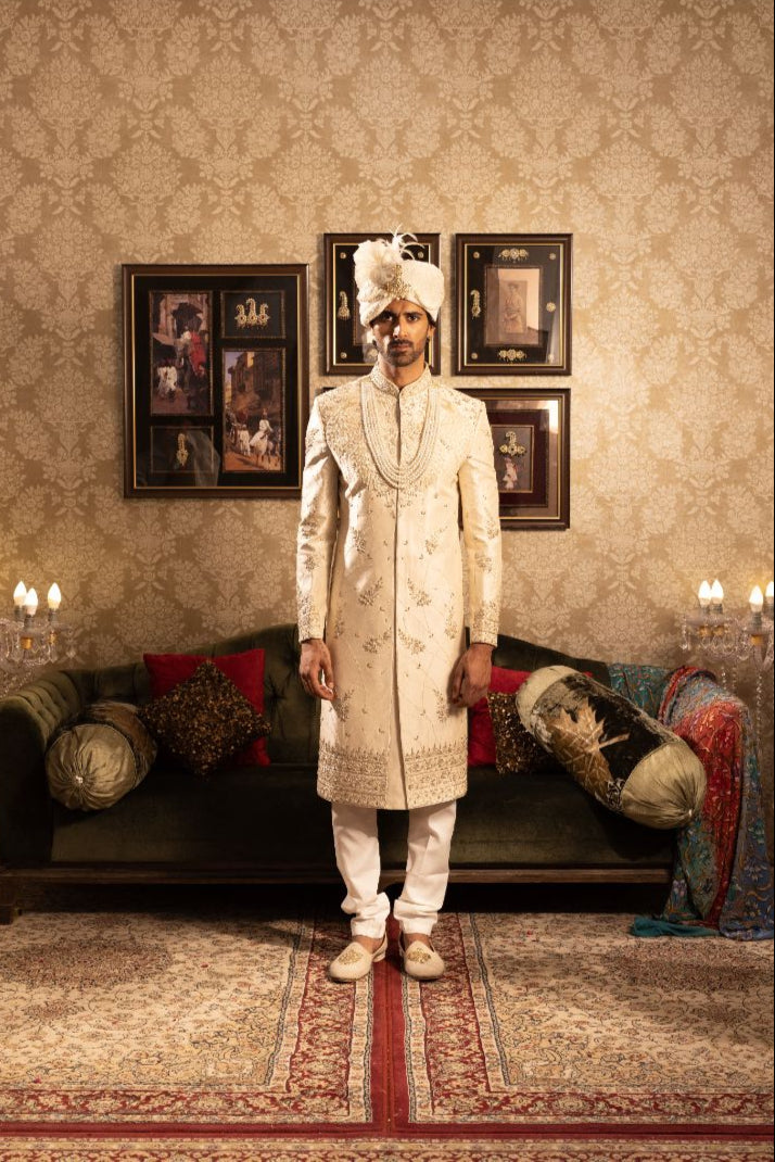 Ivory men’s silk sherwani with peacock motifs