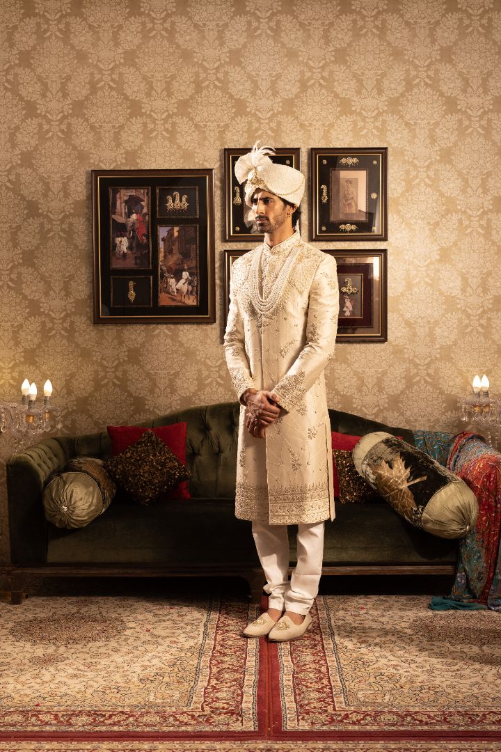 Ivory men’s silk sherwani with peacock motifs