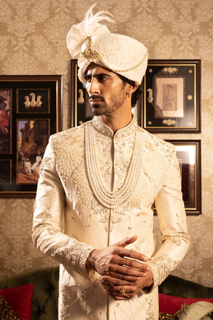 Ivory men’s silk sherwani with peacock motifs