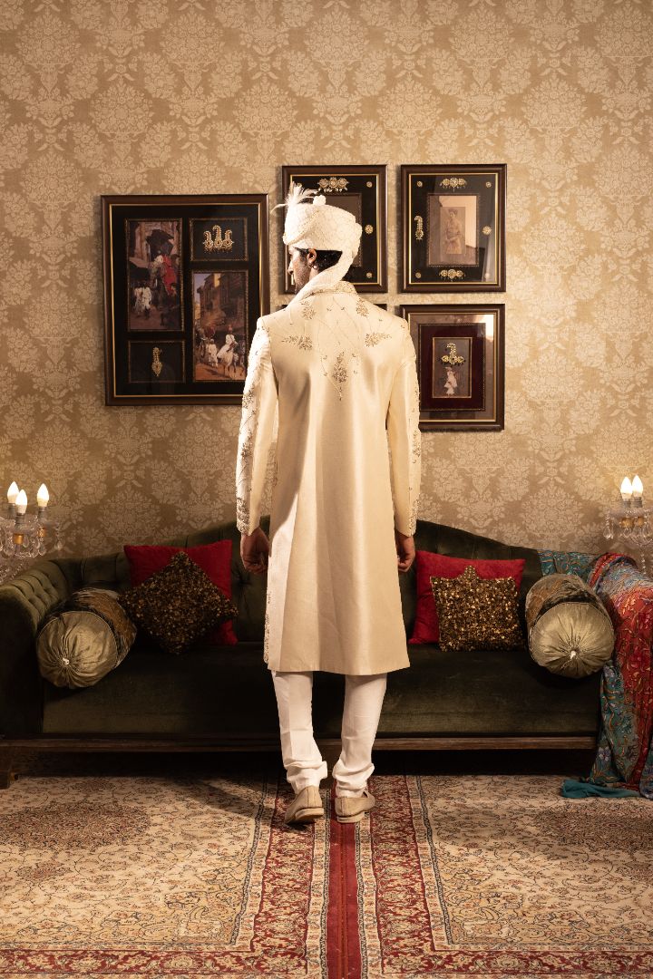 Ivory men’s silk sherwani with peacock motifs
