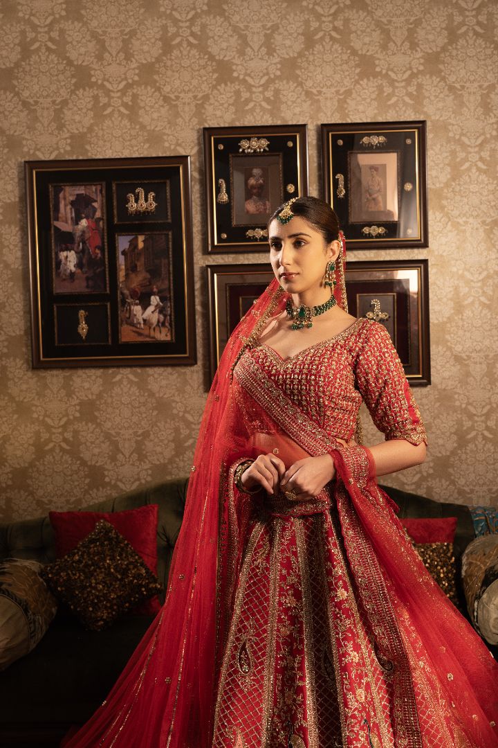 Red Silk Bridal lehenga with jaal work and peacock motifs