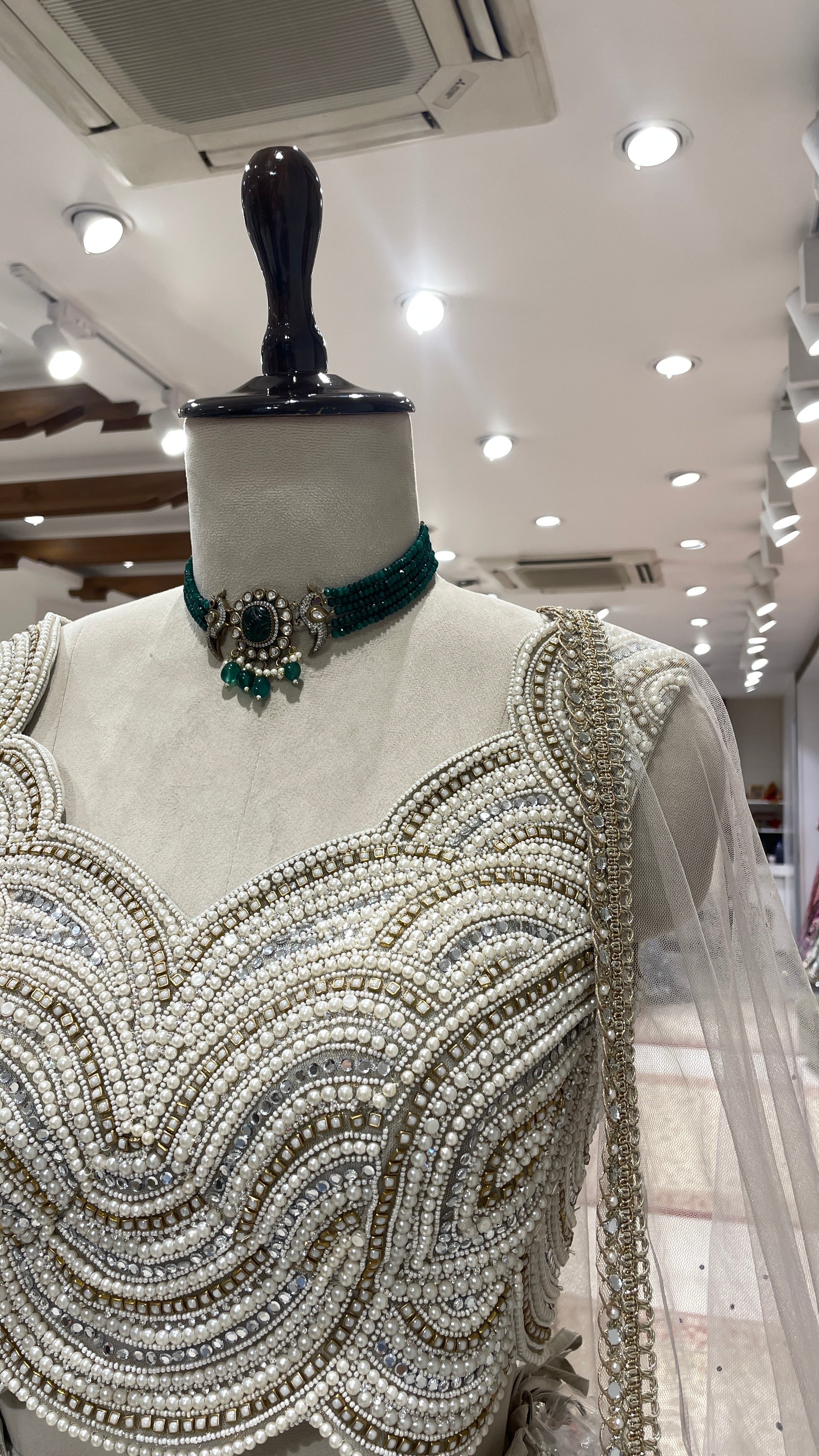 Ivory tissue lehenga with heavy embellished blouse