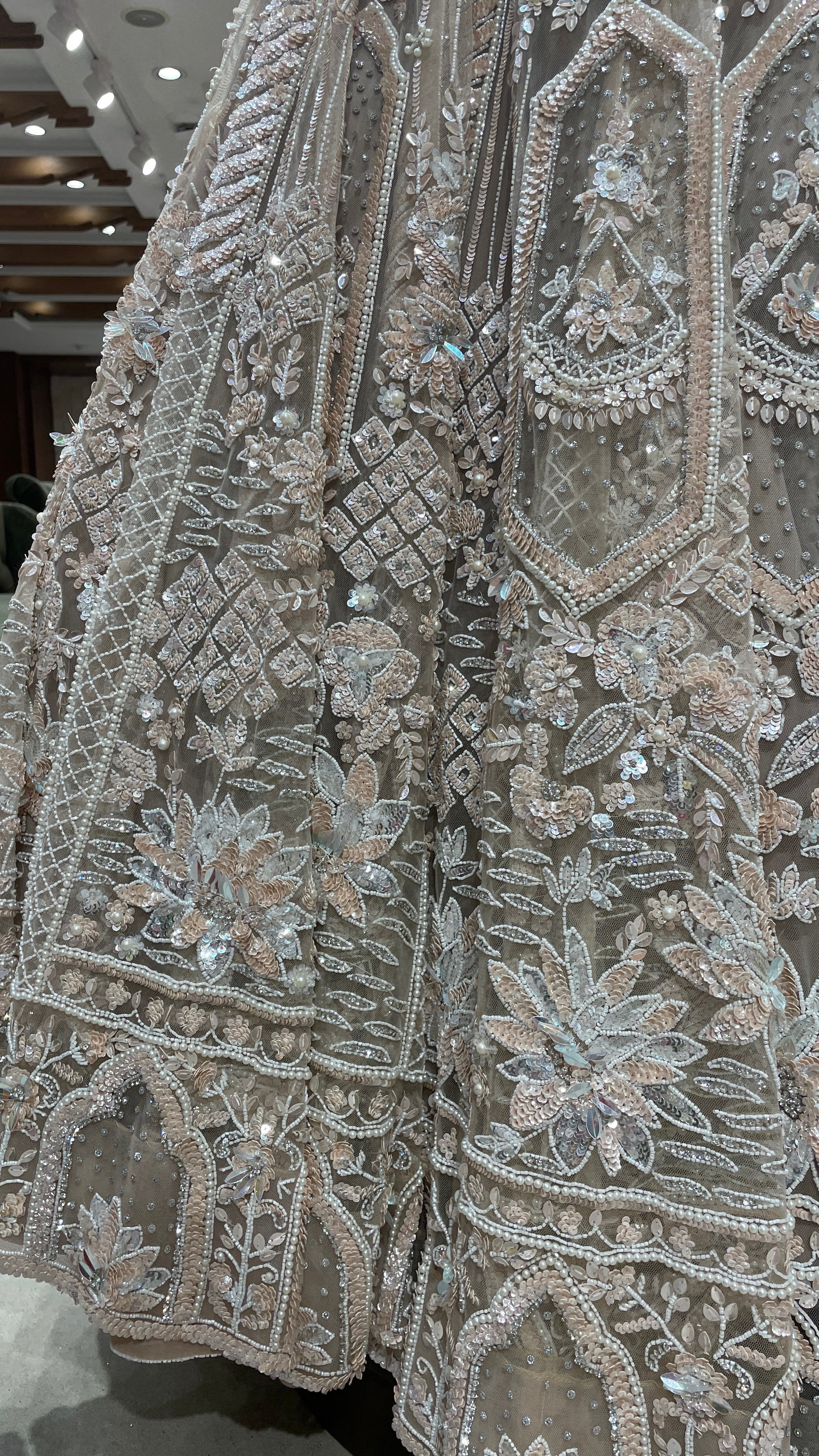 Cream net lehenga with sequins and cutdana embellishments