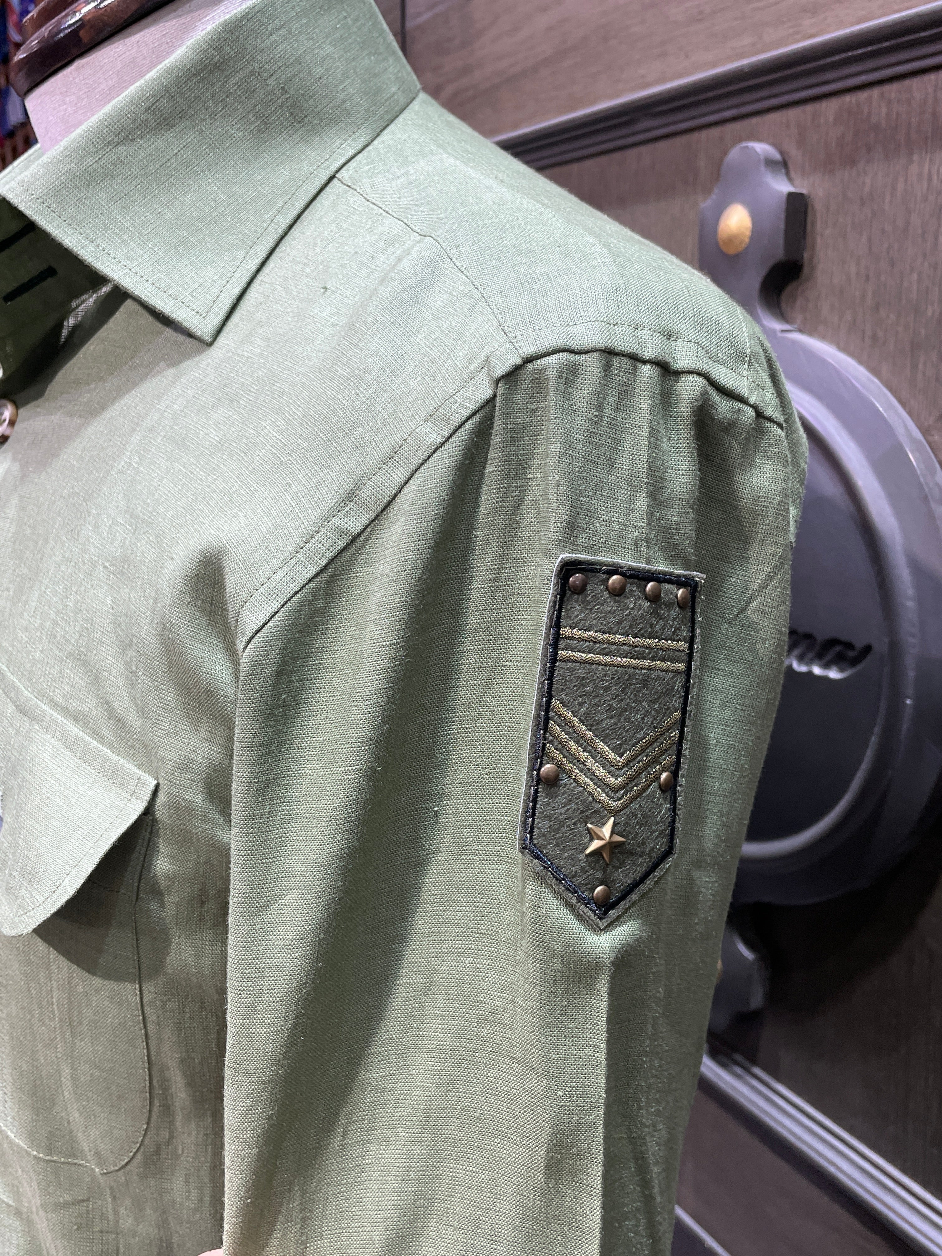 Green linen safari shirt with embroidered badges