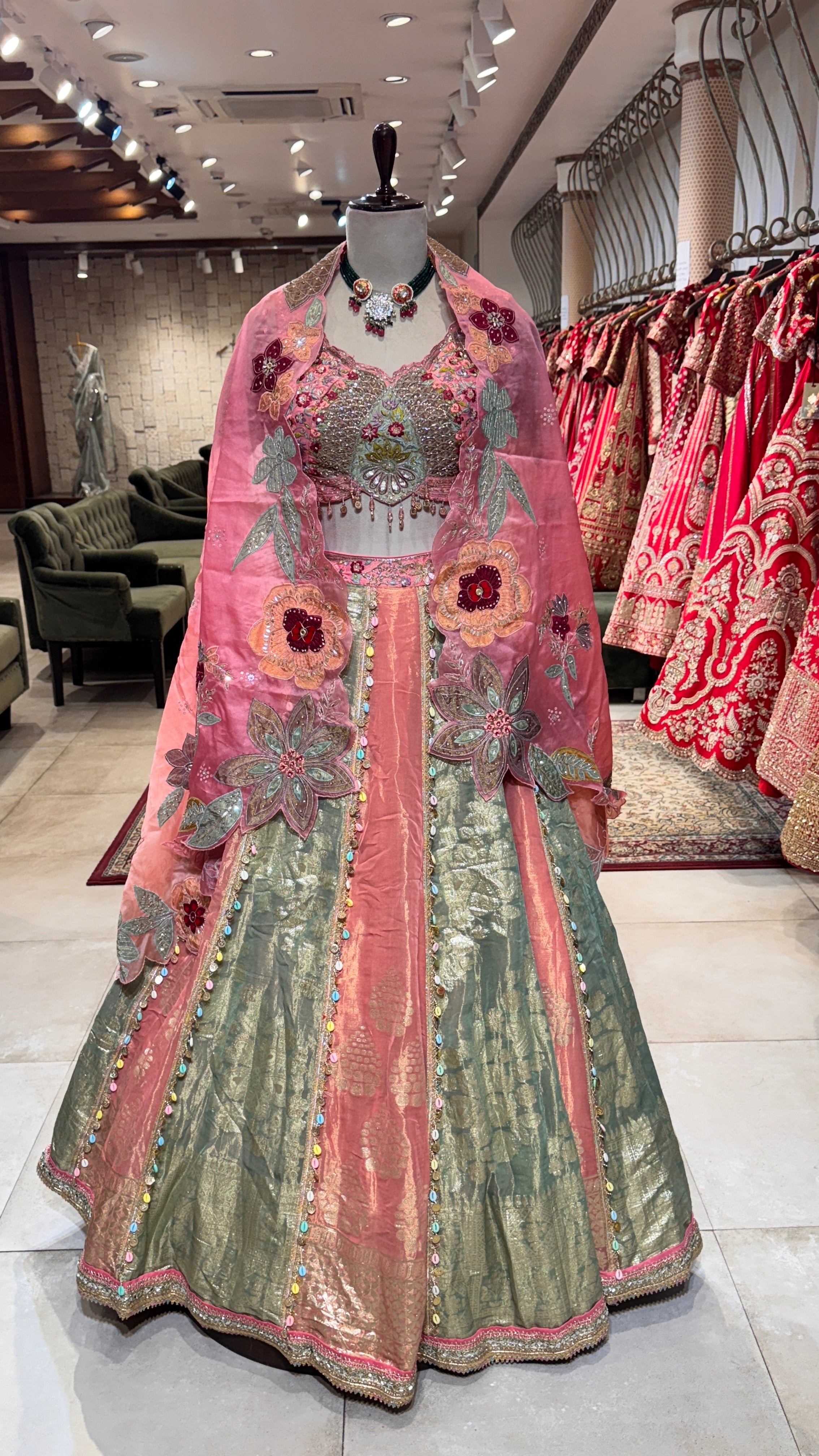 A crushed floral lehenga displayed on a mannequin, featuring a multicolored design with floral prints and a traditional silhouette.