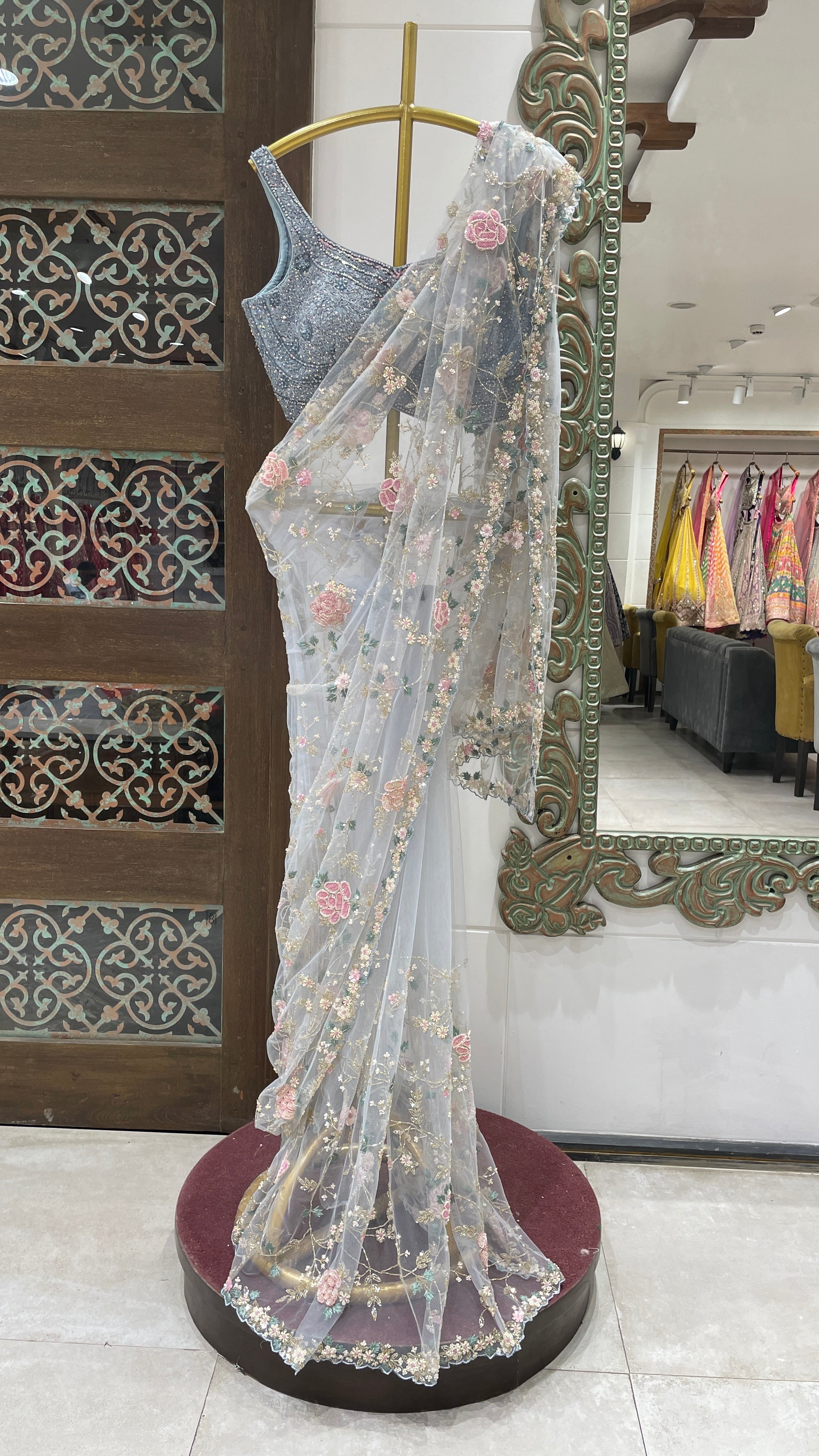 Pastel blue net saree with floral motifs