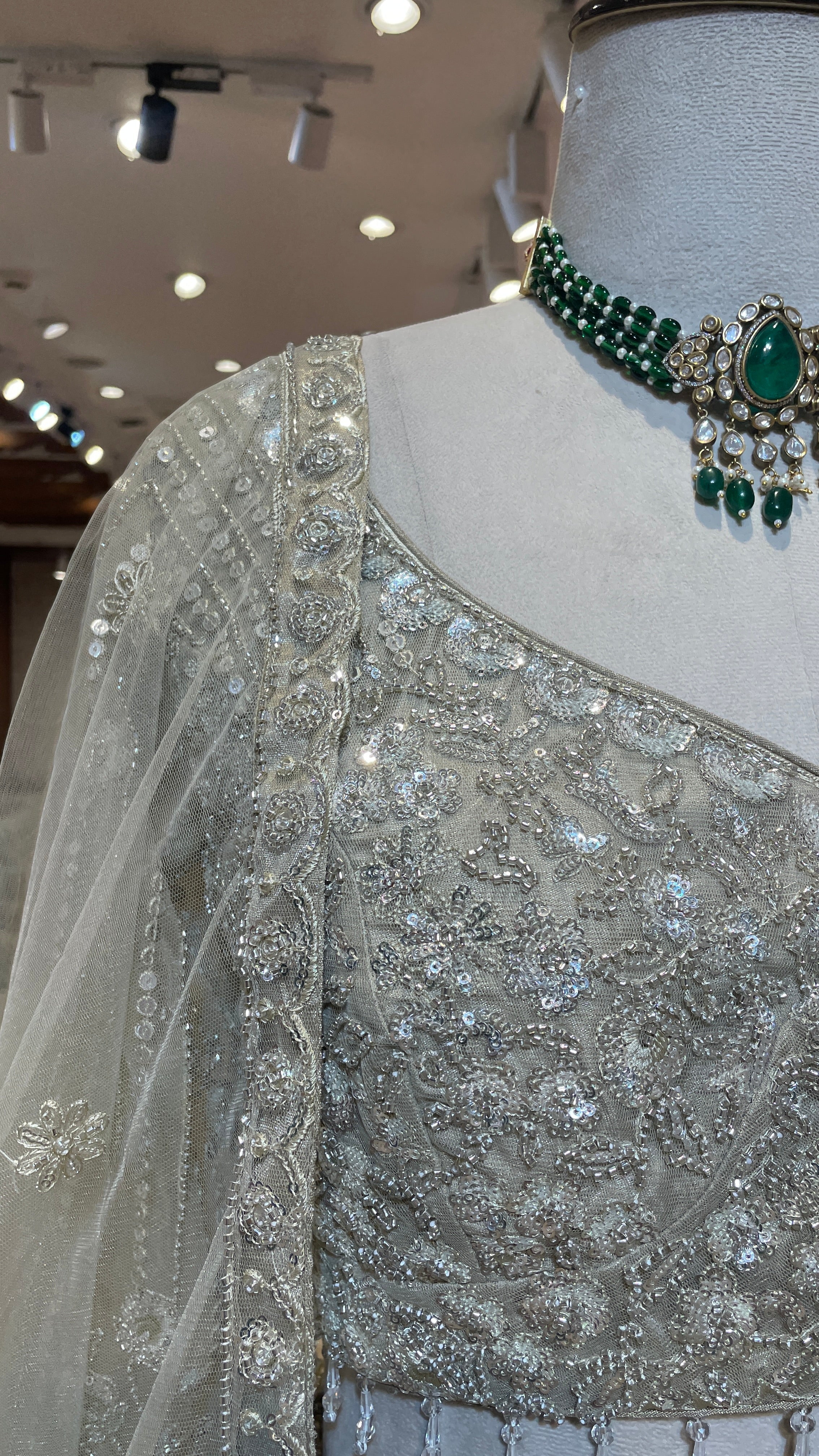 Cream net lehenga with cutdana and floral motifs