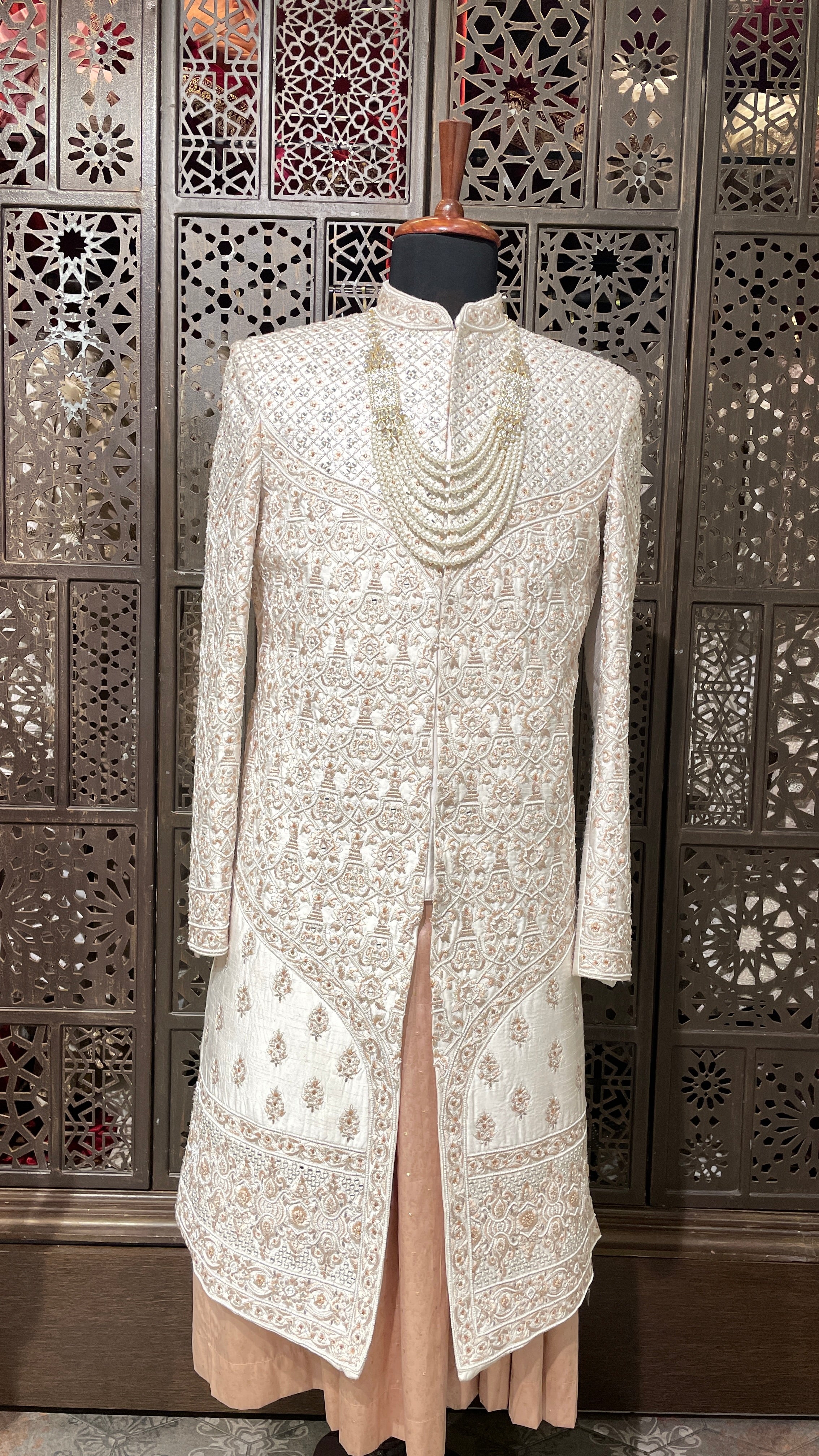 Cream men’s Anarkali style sherwani with peach embroidery
