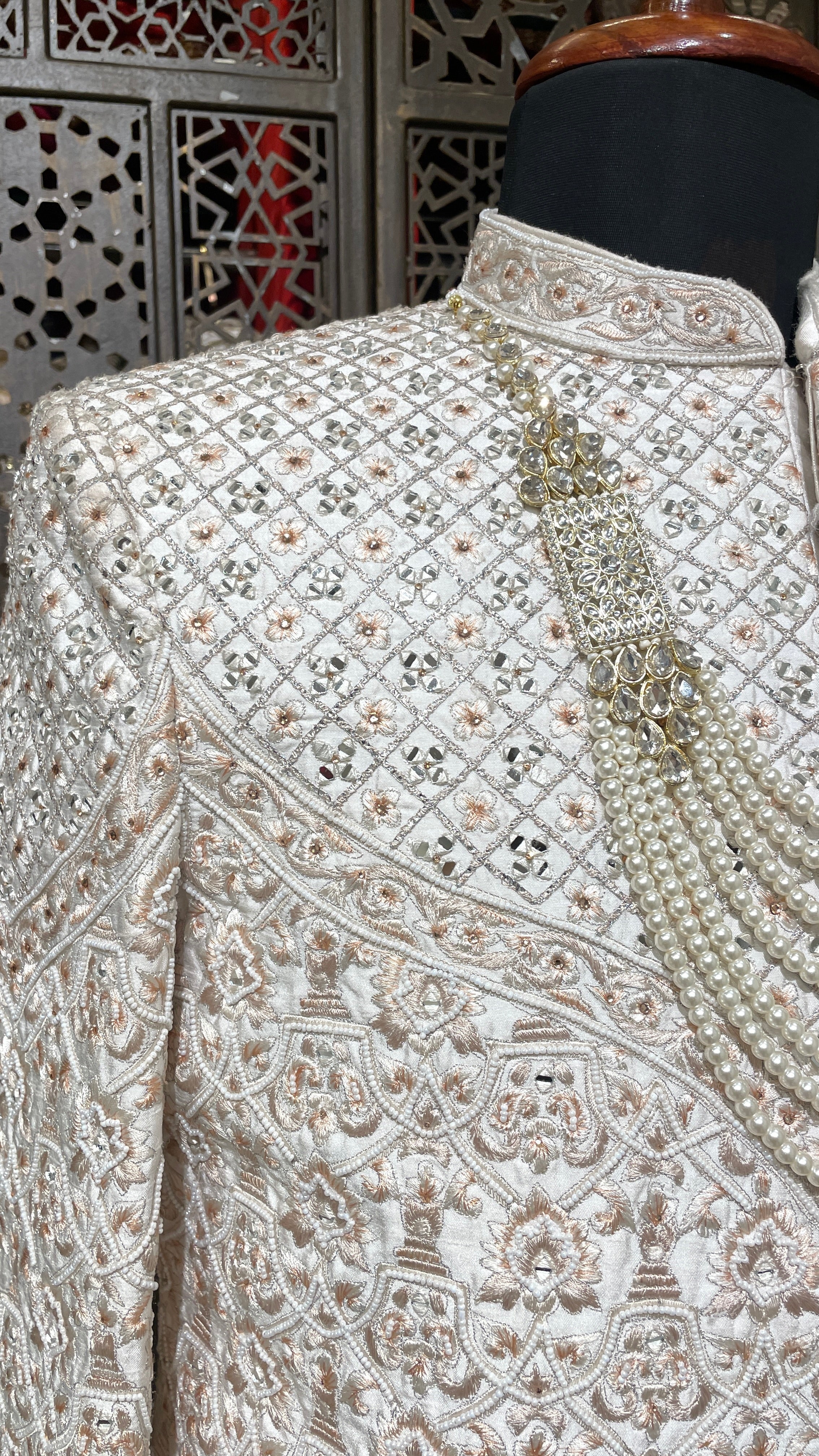 Cream men’s Anarkali style sherwani with peach embroidery