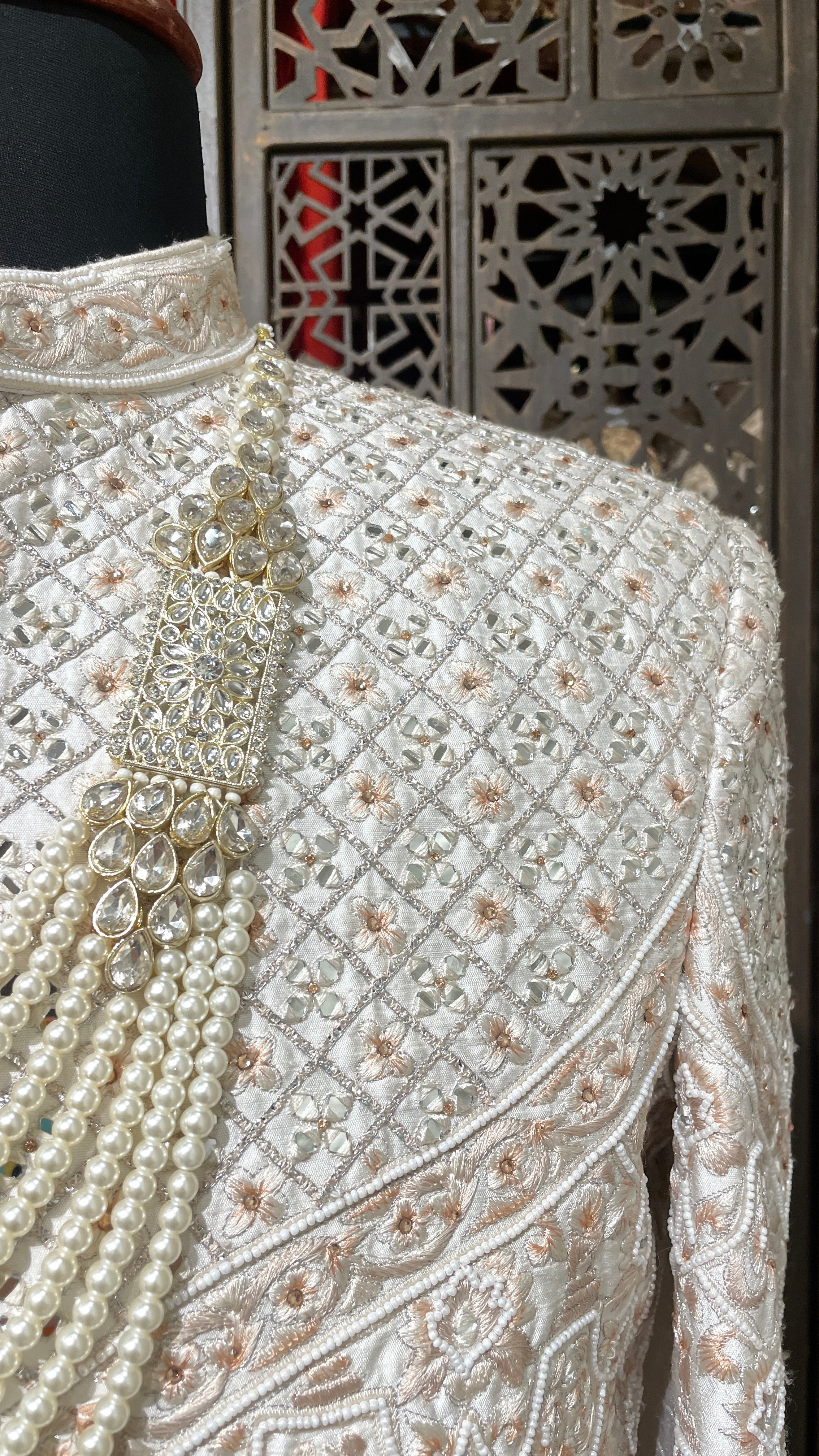 Cream men’s Anarkali style sherwani with peach embroidery