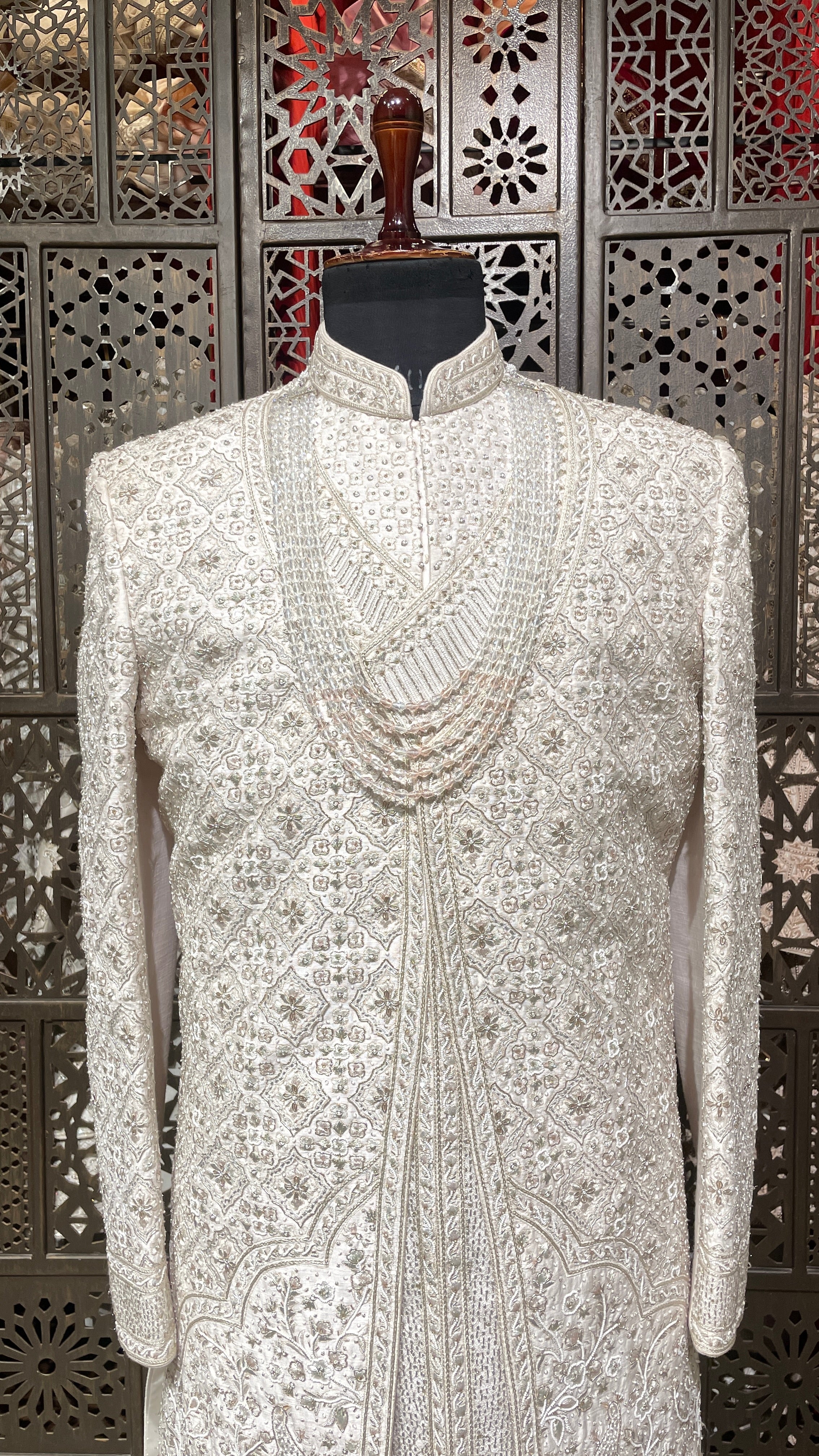 Cream layered sherwani with peacock motifs and zariwork