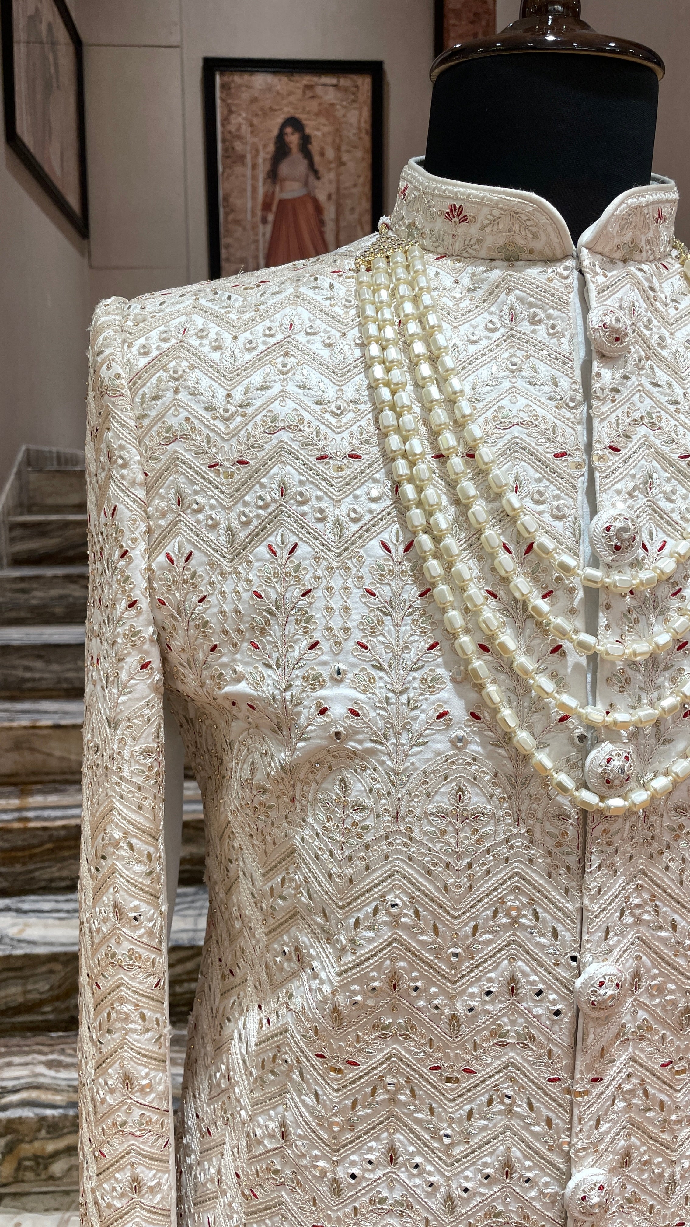Cream silk sherwani with red and gold embroidery