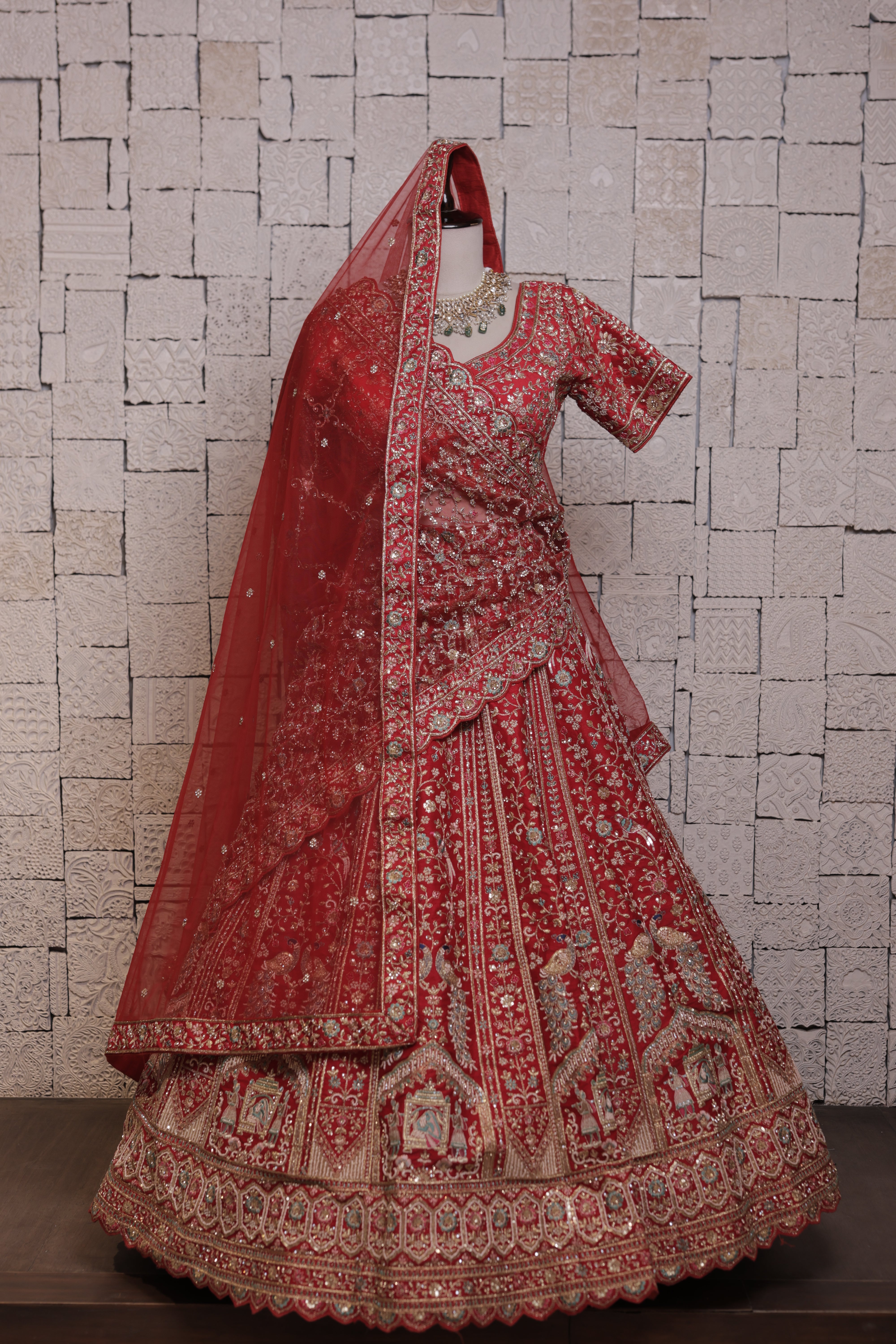 Red bridal lehenga with Doli mor embroidery design