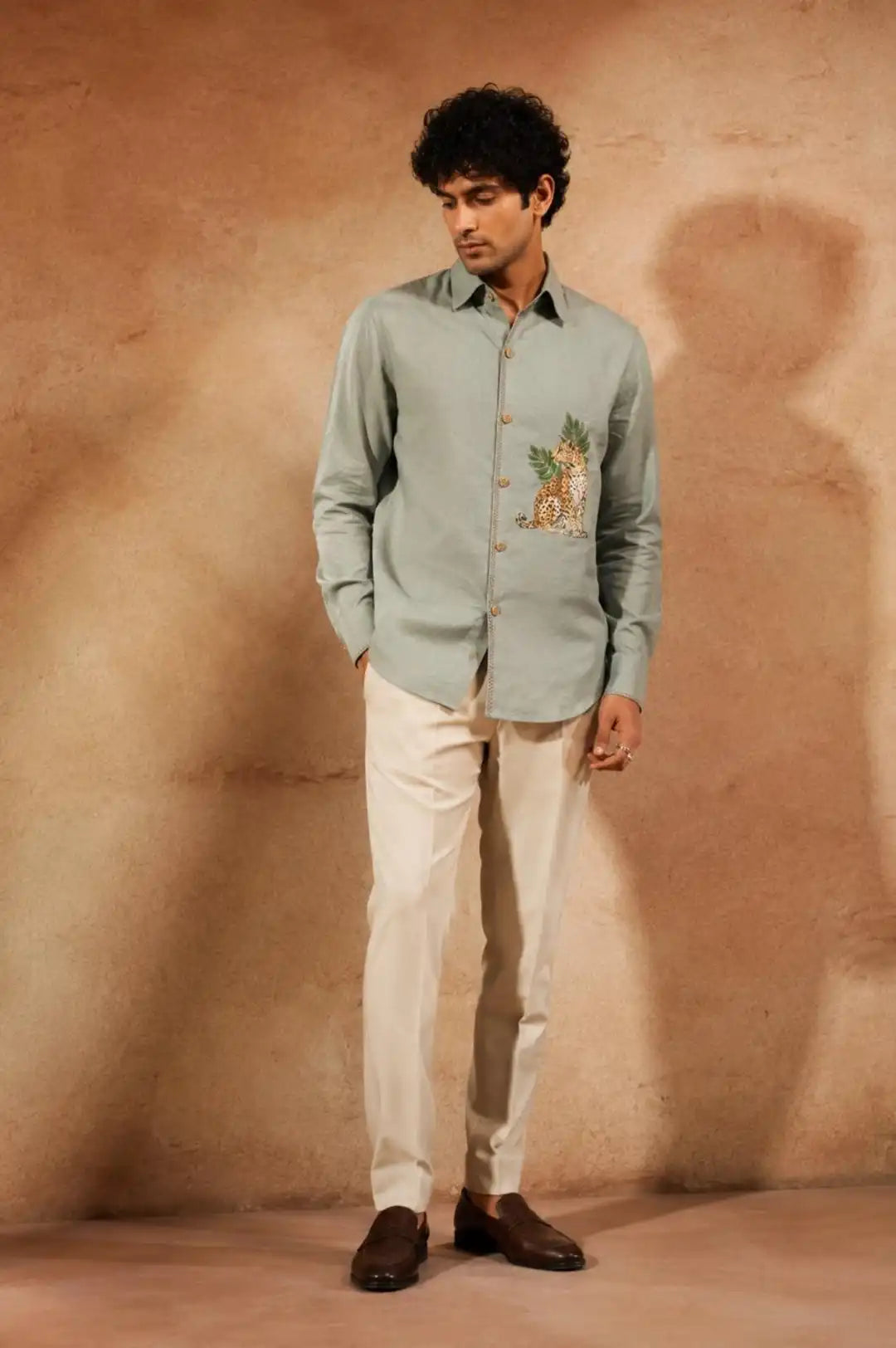 Sage green linen hand-painted shirt with signature leopard & tropical leaf artwork on chest