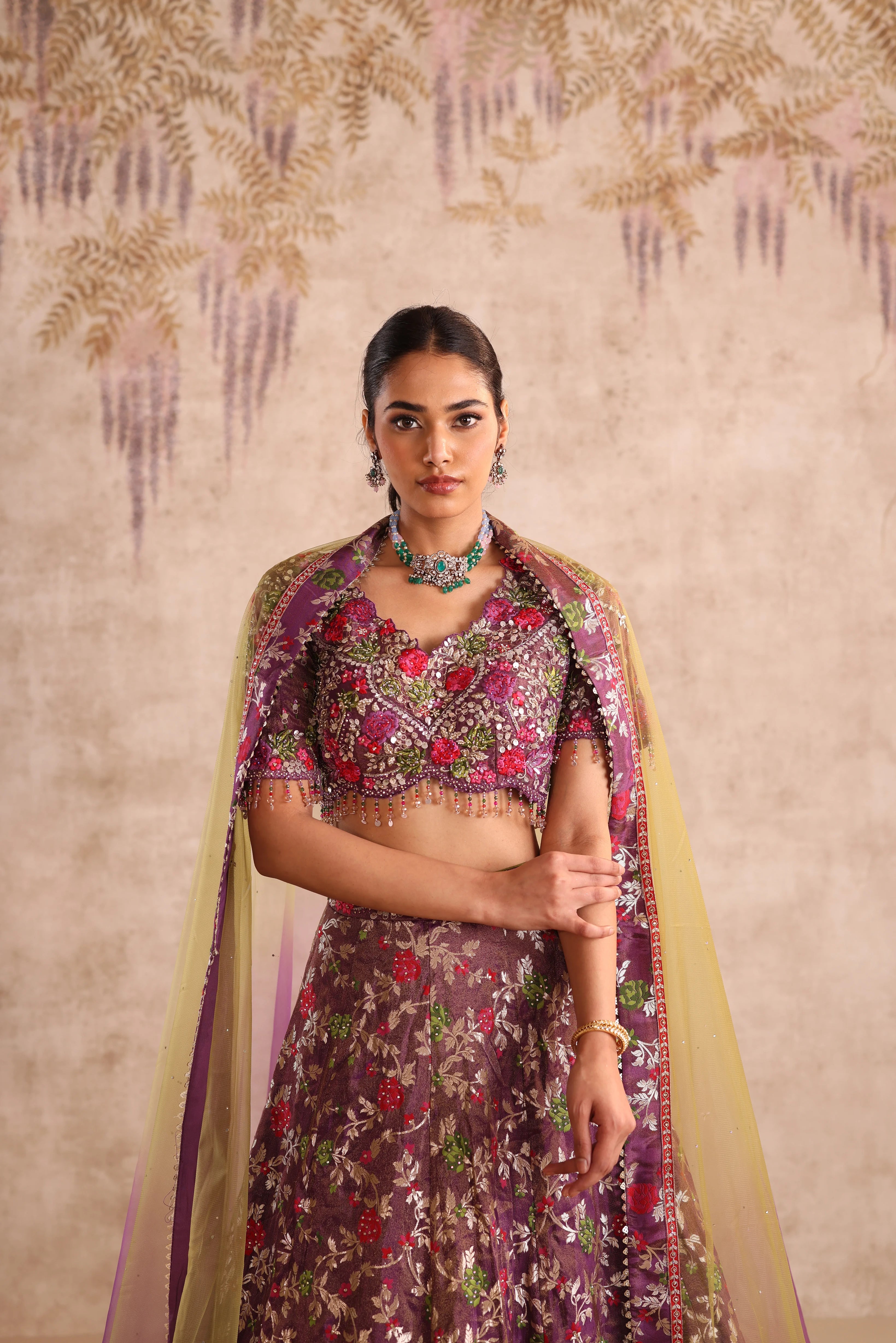 Woman wearing a floral traditional outfit with a beige background