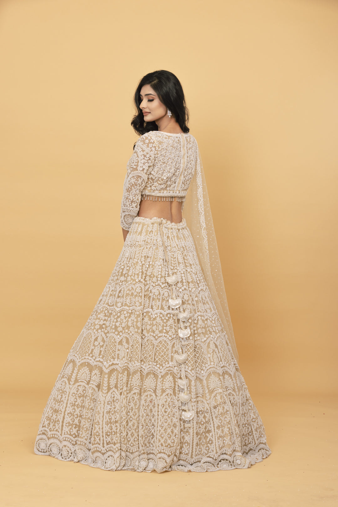 Beige net lehenga with pearl embellishments