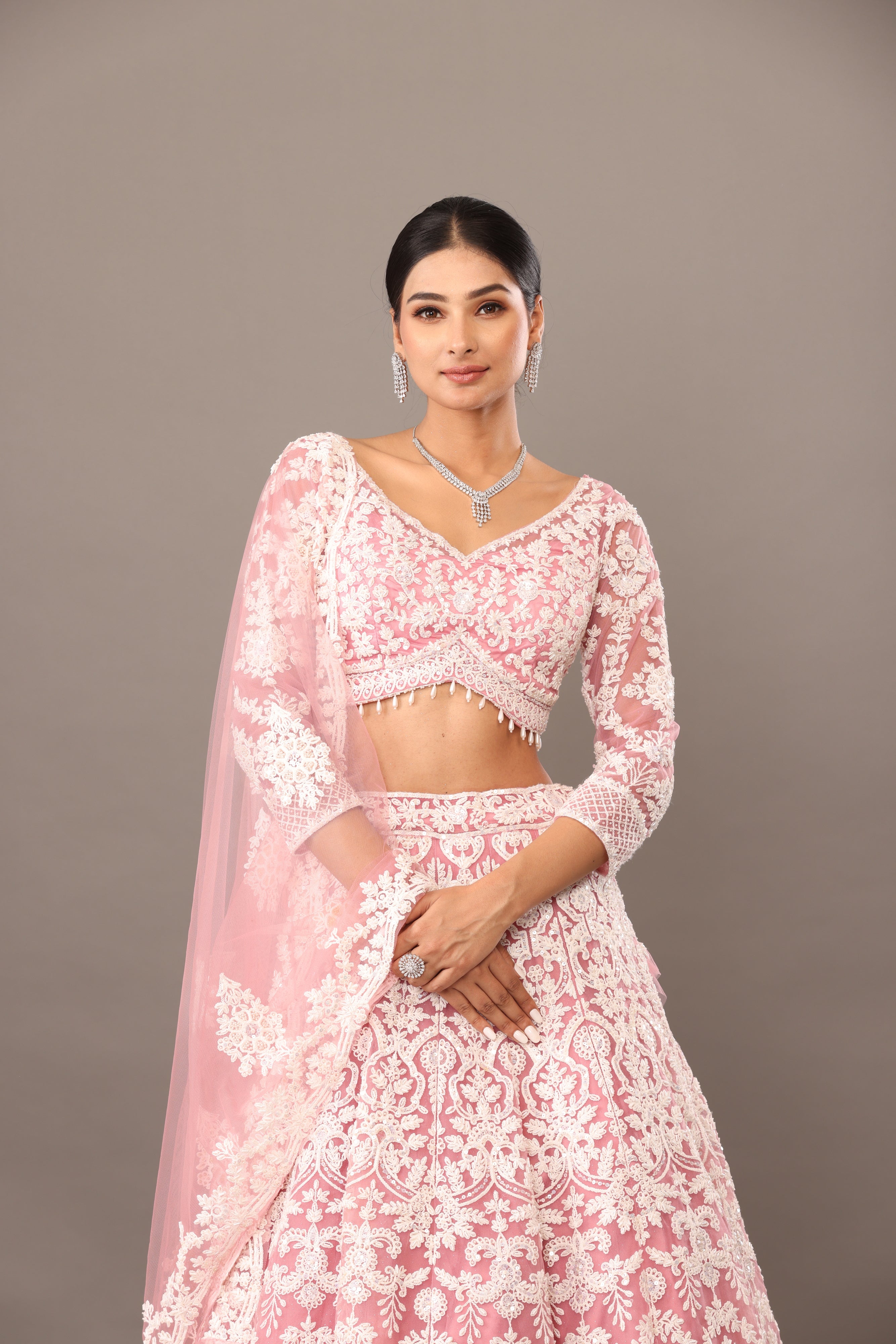 Pink net lehenga with pearl embellishments