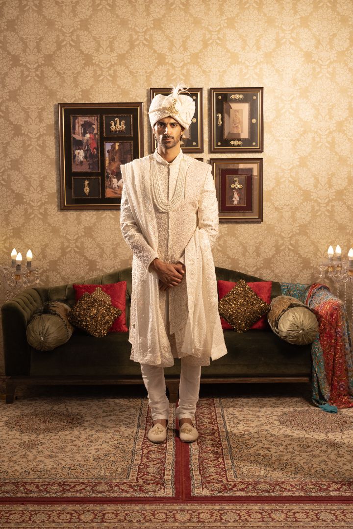 Ivory layered sherwani with pearl and bead embellishments