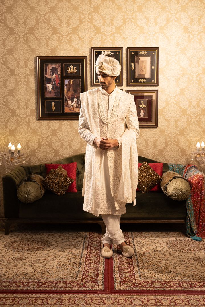 Ivory layered sherwani with pearl and bead embellishments