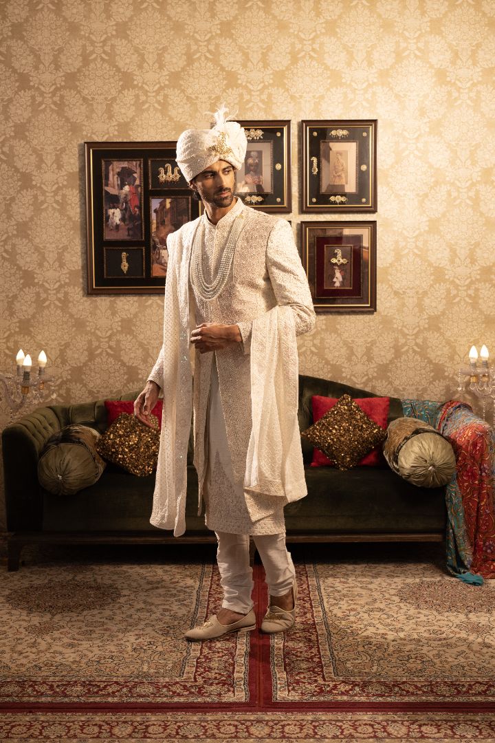 Ivory layered sherwani with pearl and bead embellishments