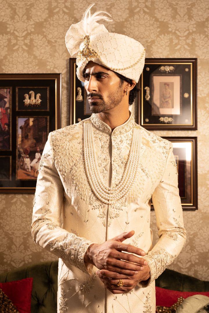 Ivory men’s silk sherwani with peacock motifs