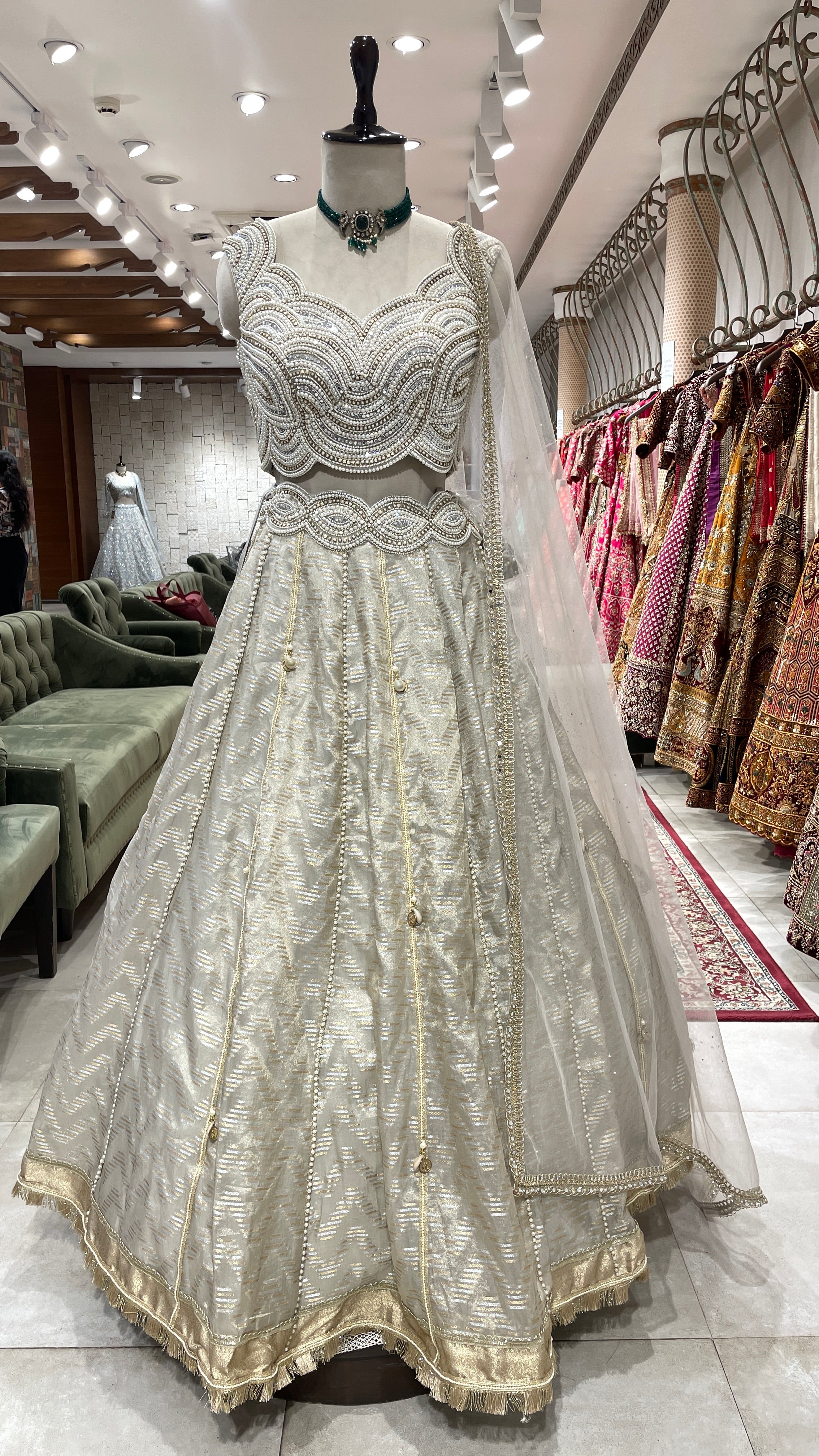Ivory tissue lehenga with heavy embellished blouse
