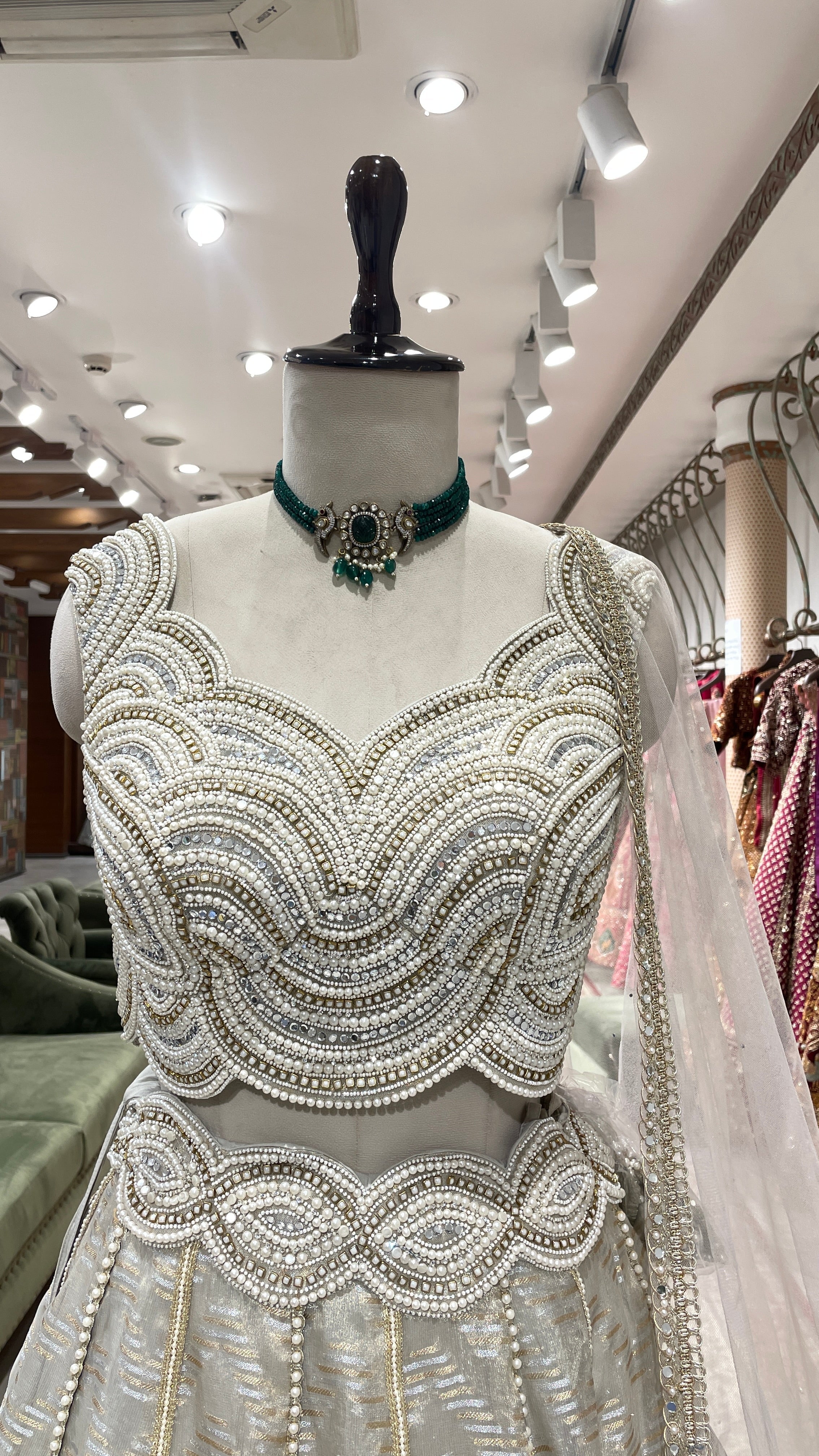 Ivory tissue lehenga with heavy embellished blouse