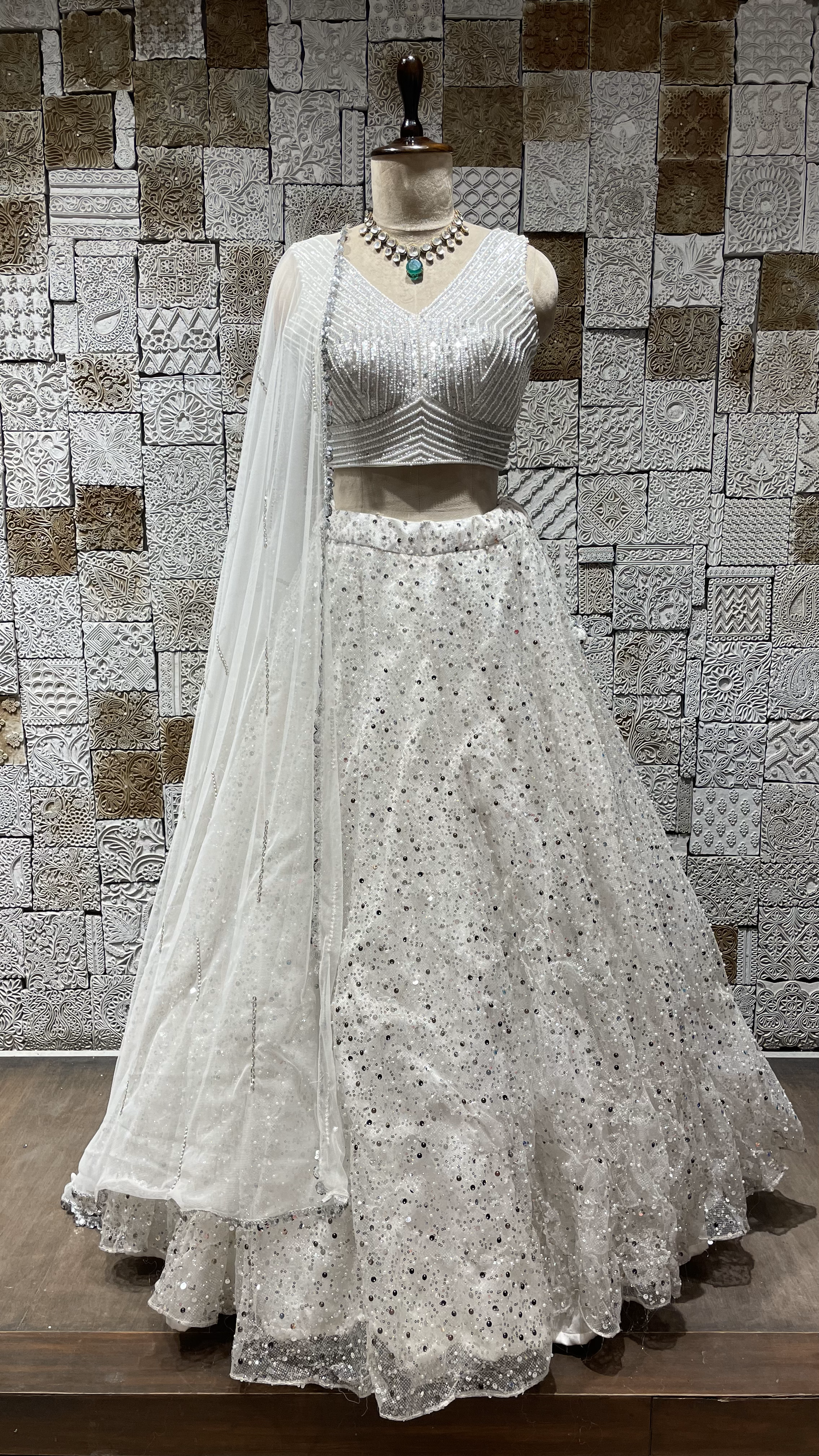 White Net lehenga with heavy embellished blouse