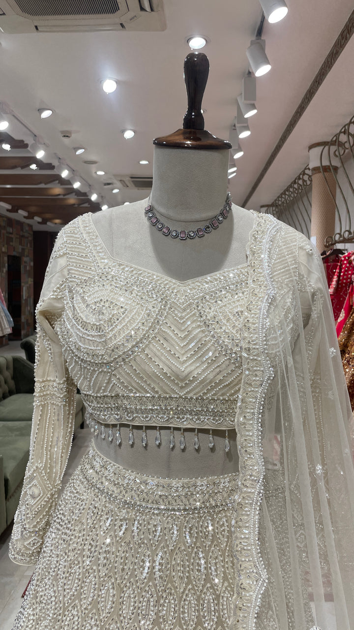 Ivory net lehenga with sequin embellishments