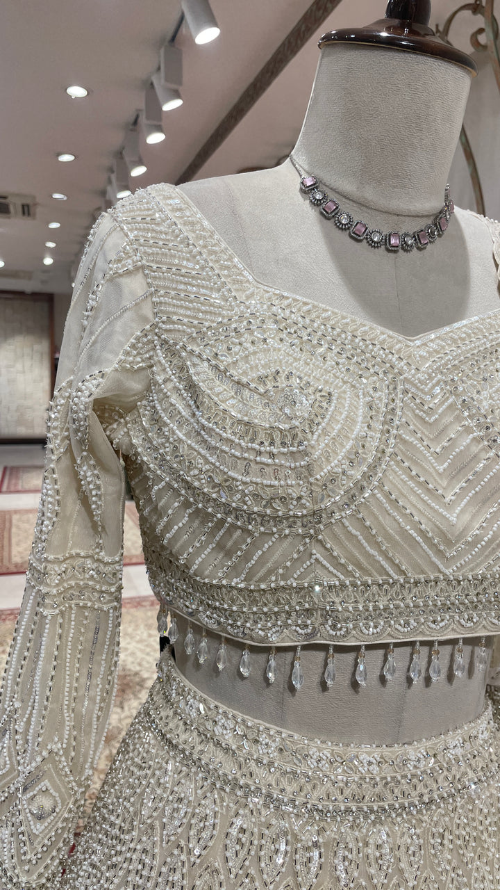 Ivory net lehenga with sequin embellishments