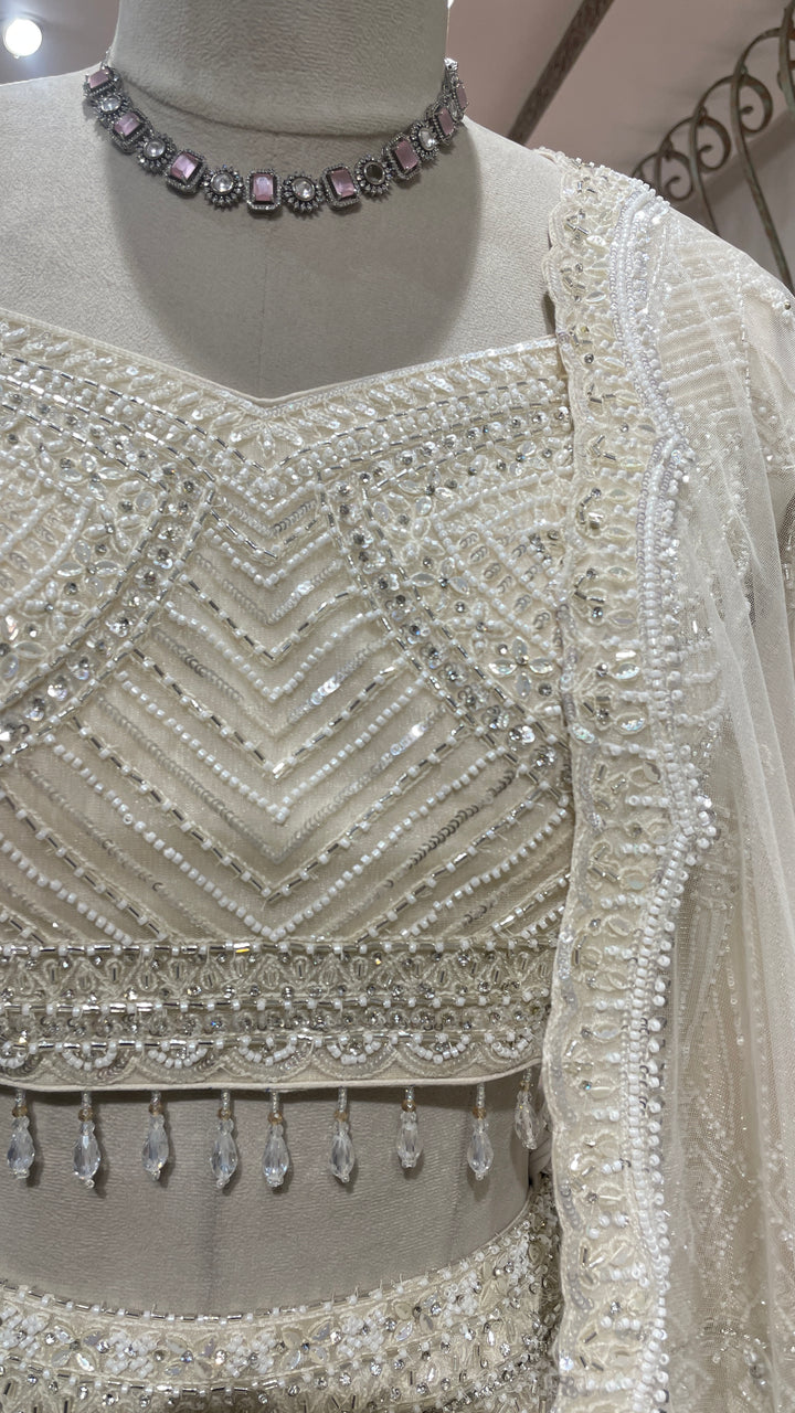 Ivory net lehenga with sequin embellishments