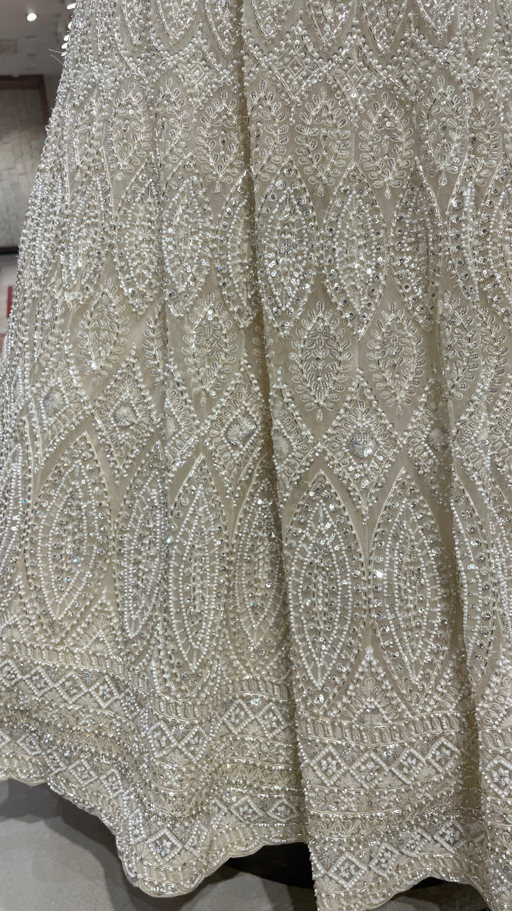 Ivory net lehenga with sequin embellishments