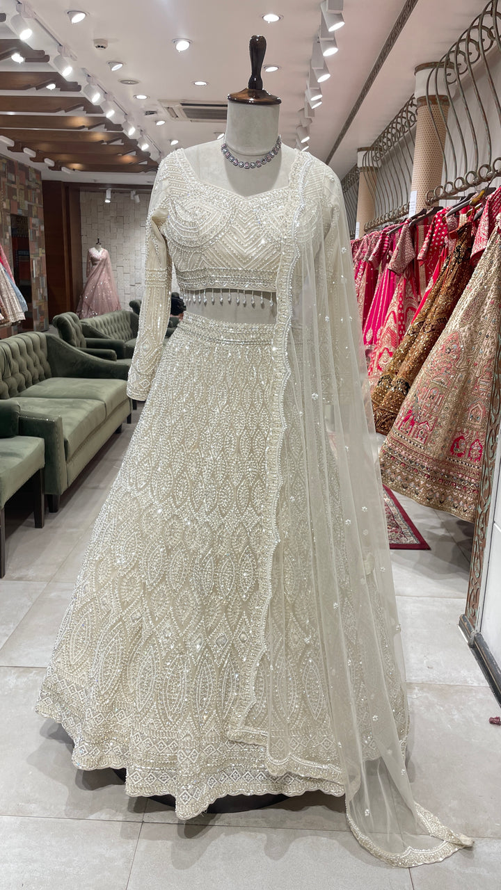 Ivory net lehenga with sequin embellishments