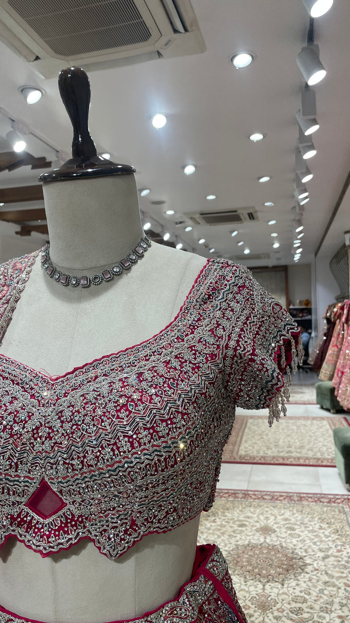 Pink net lehenga with floral motifs