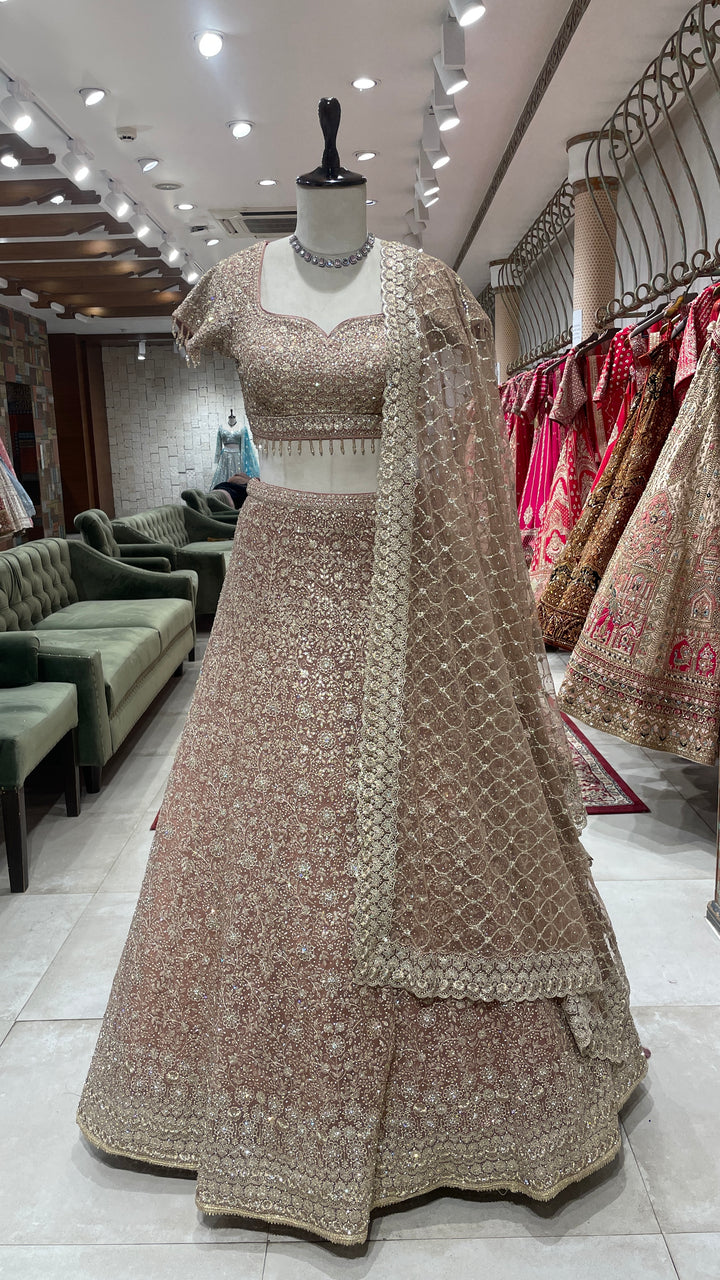 Gold net lehenga with floral motifs