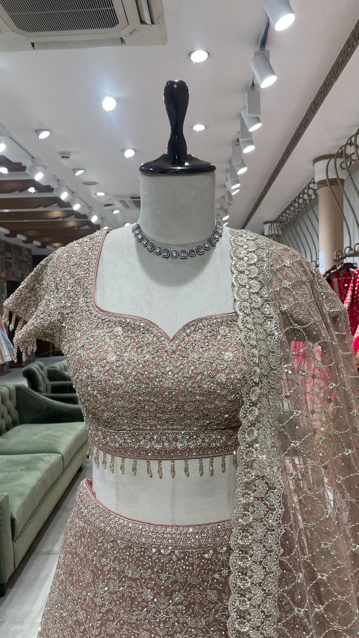 Gold net lehenga with floral motifs