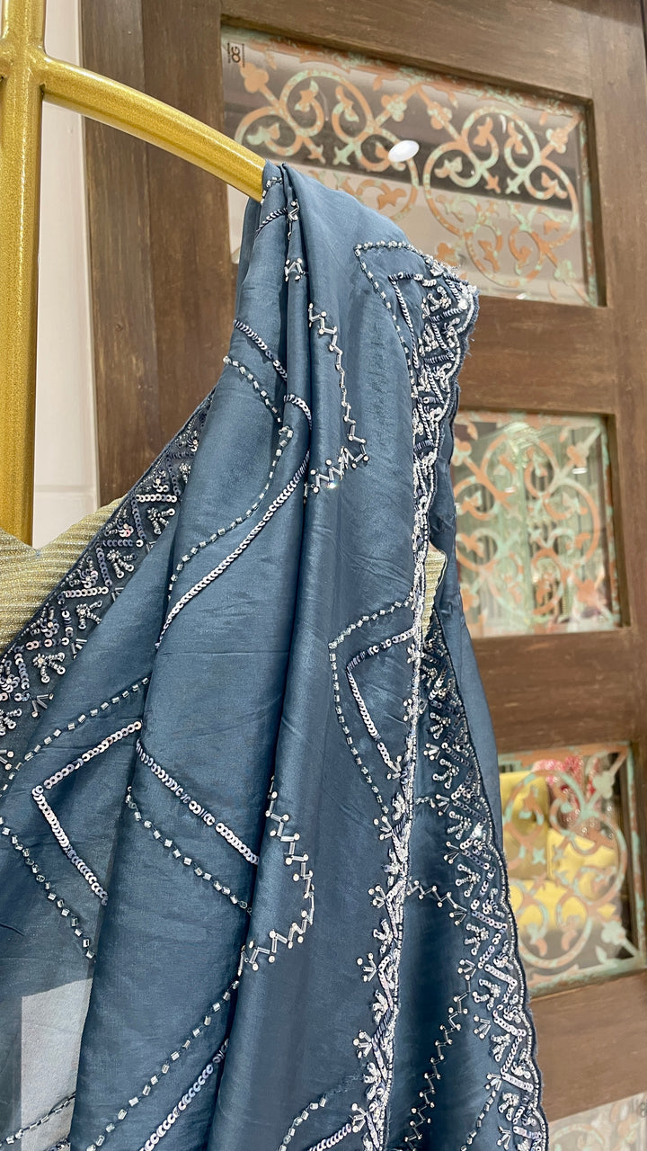 Blue organza saree with cutdana border