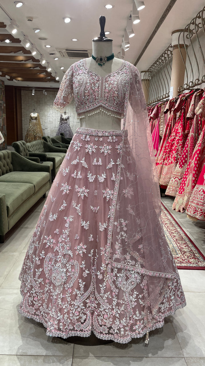 Pink net lehenga with mirrorwork and floral motifs