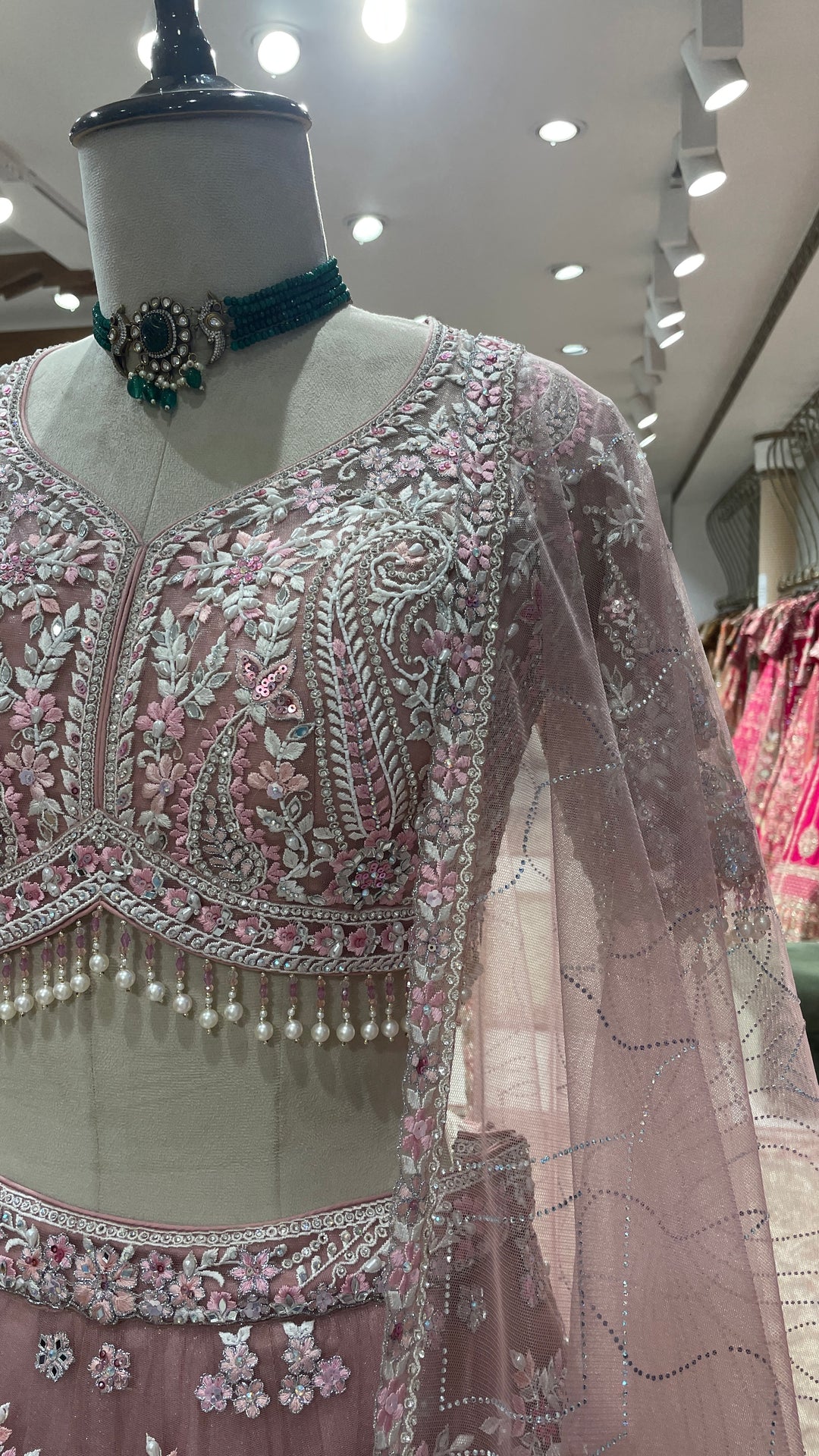 Pink net lehenga with mirrorwork and floral motifs