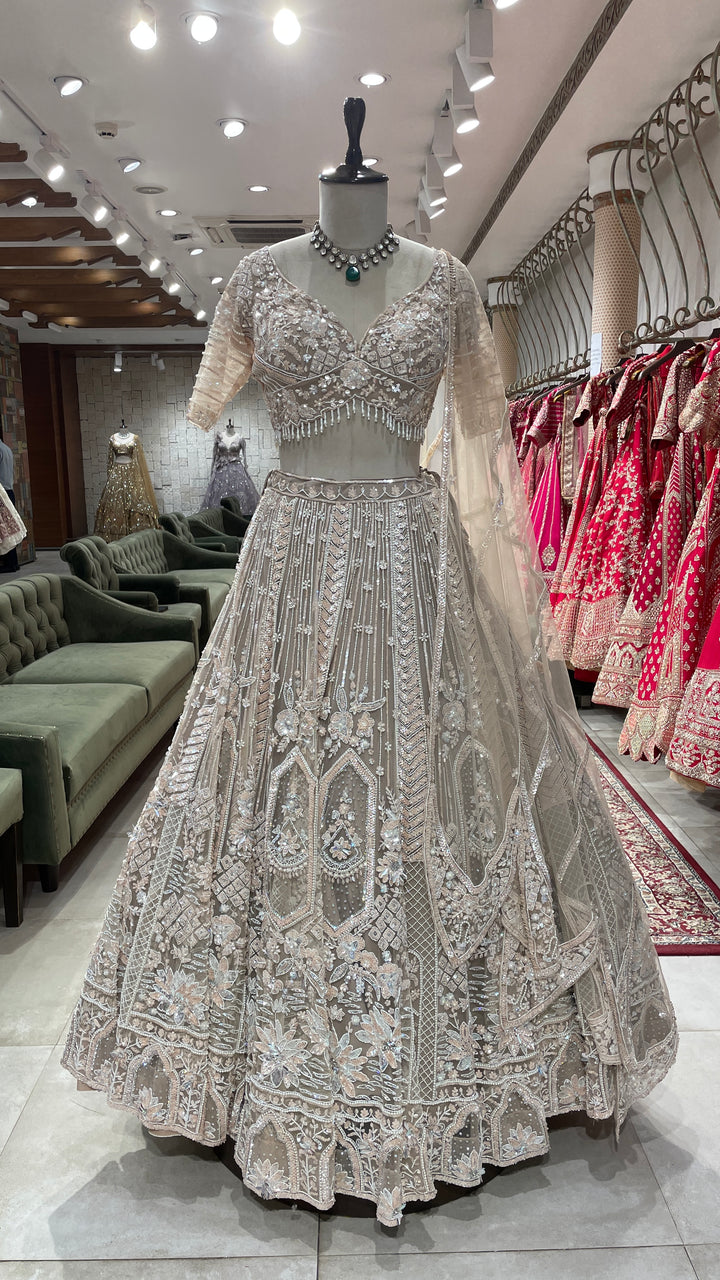 Cream net lehenga with sequins and cutdana embellishments