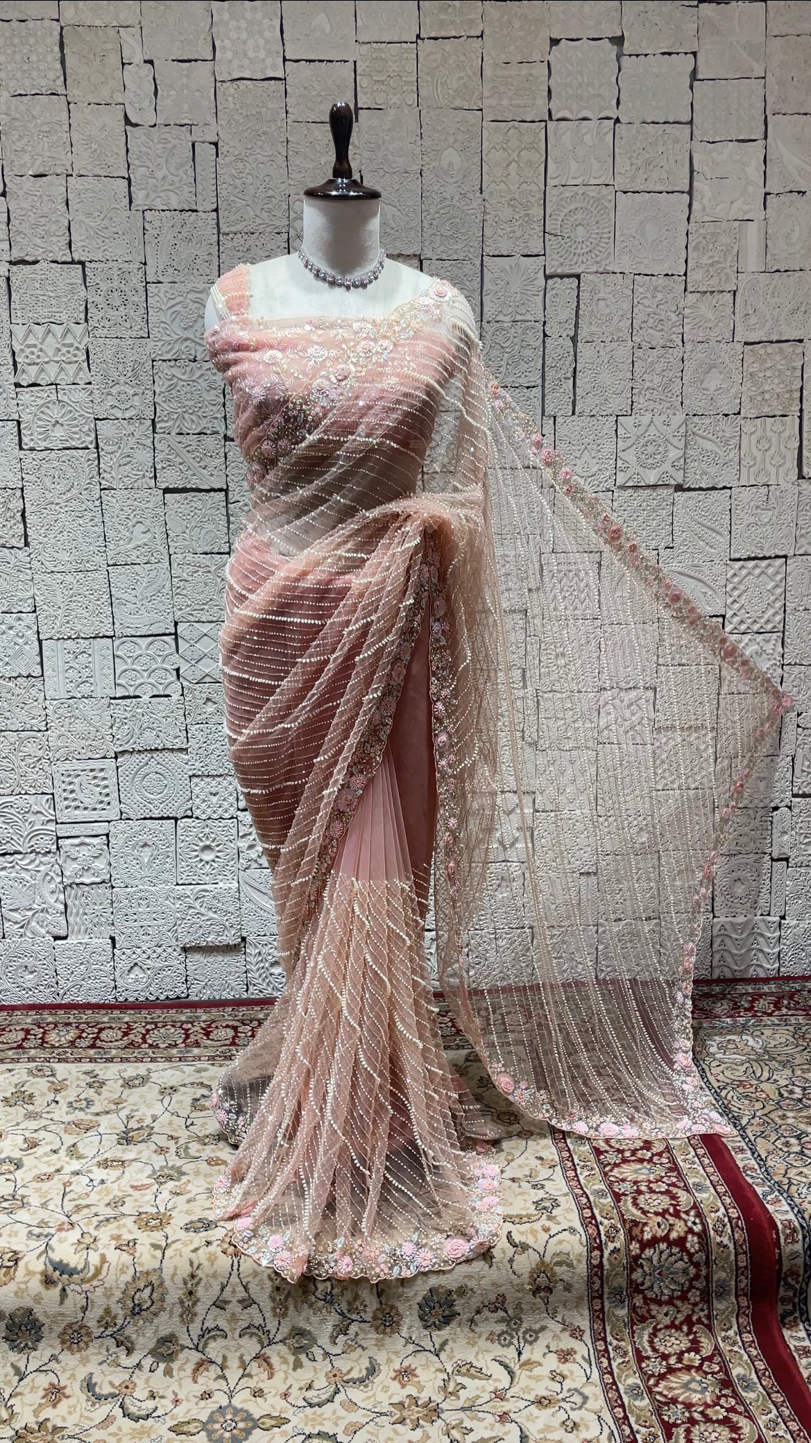 Pastel pink net saree with floral motifs