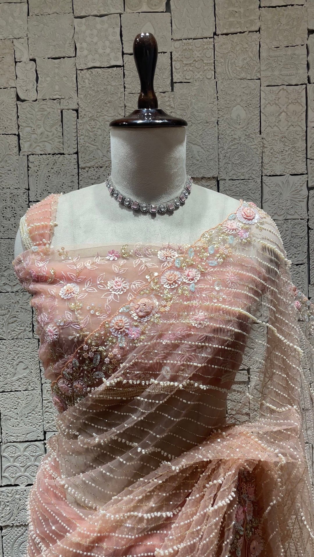 Pastel pink net saree with floral motifs