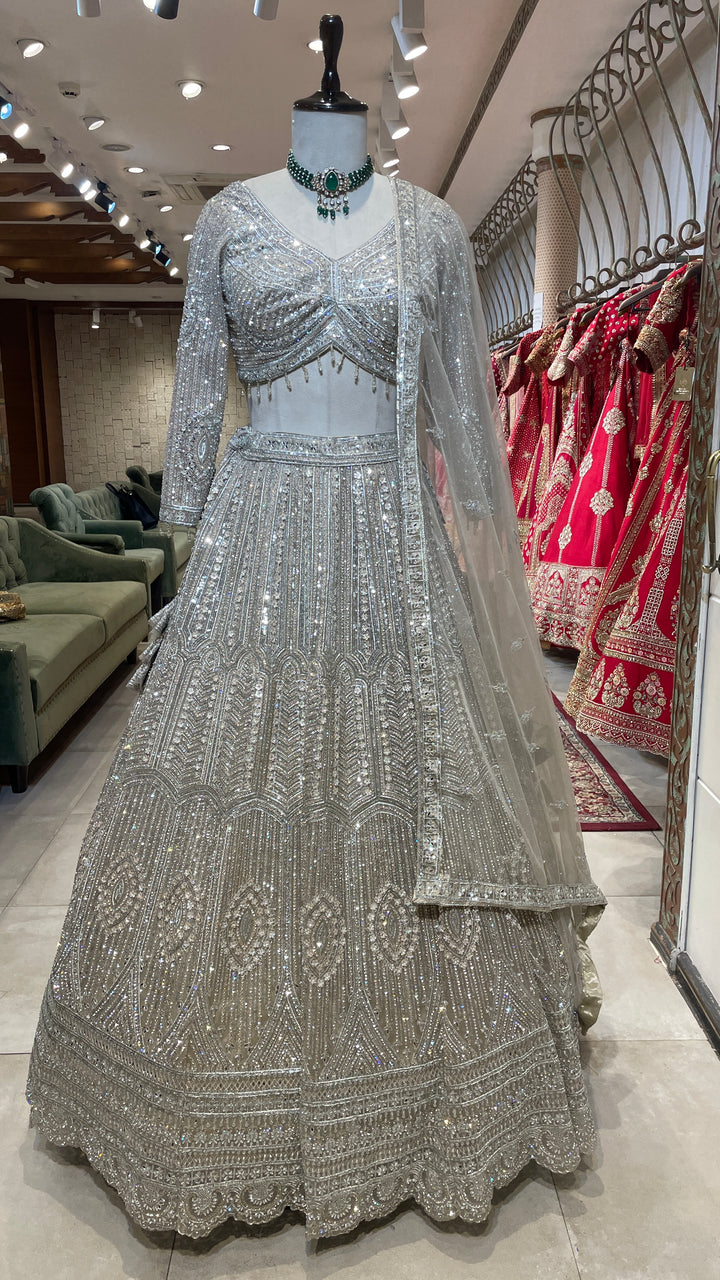 Ivory net lehenga with sequin embellishments