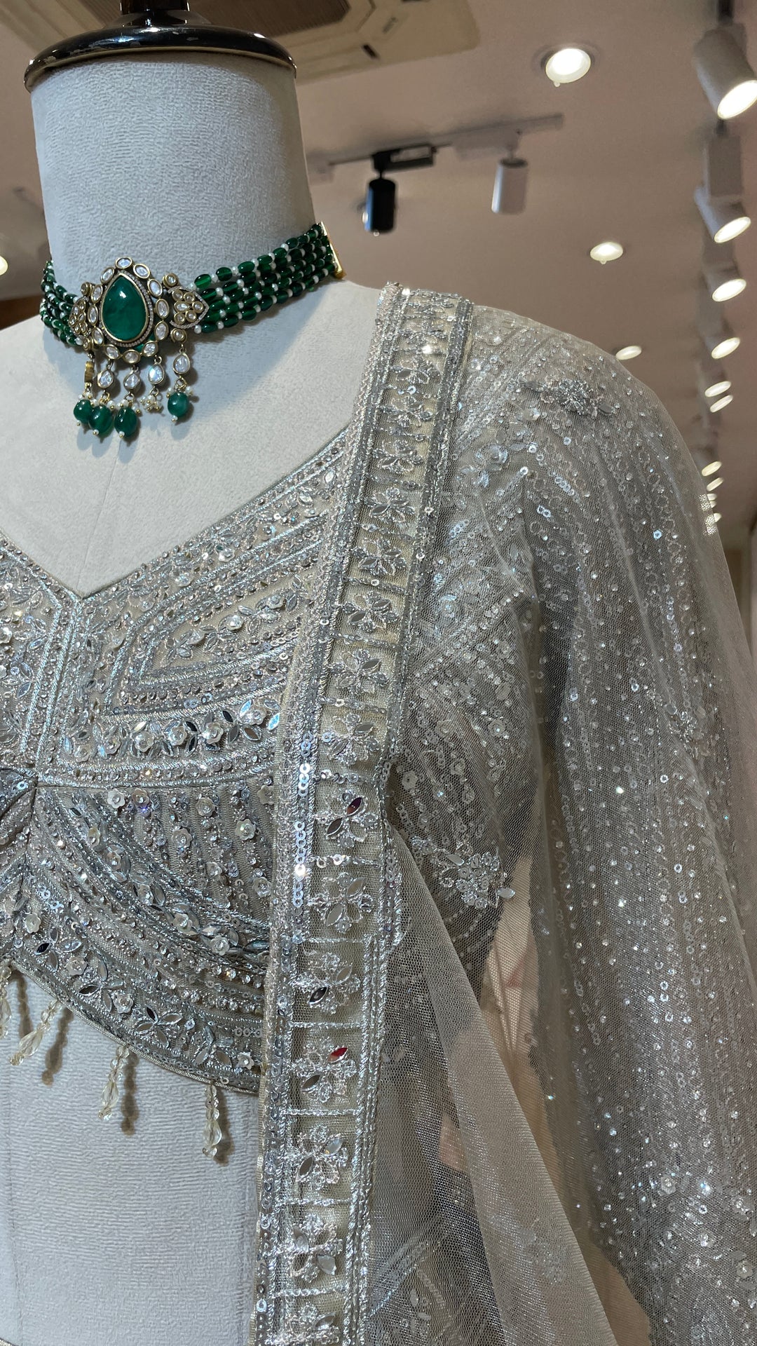 Ivory net lehenga with sequin embellishments