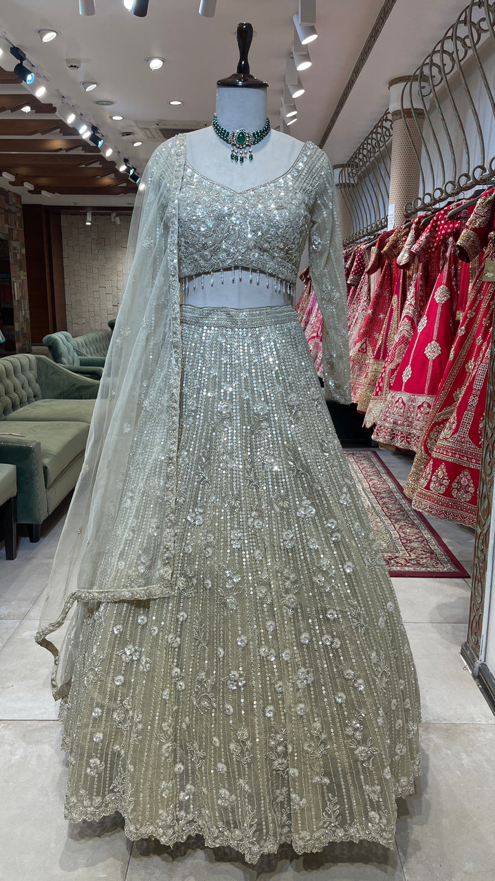 Cream net lehenga with cutdana and floral motifs