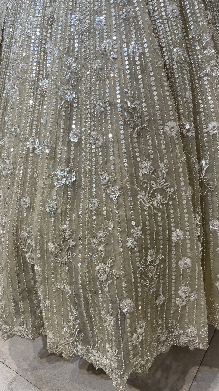 Cream net lehenga with cutdana and floral motifs