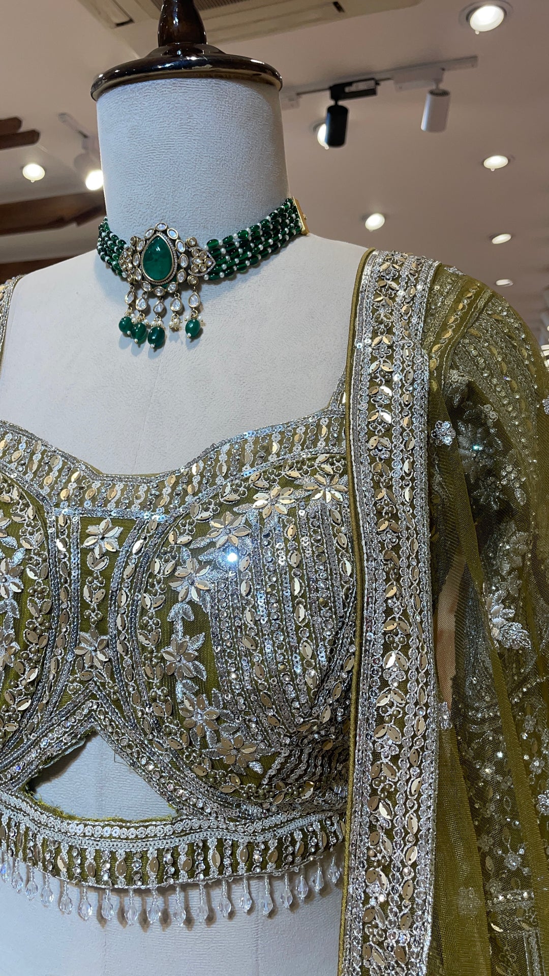 Green net lehenga with silver embellishments